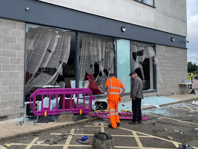 <p>Damage at the Holiday Inn Express in Rotherham, South Yorkshire, where anti-immigration rioters smashed the windows before starting fires on Sunday</p>