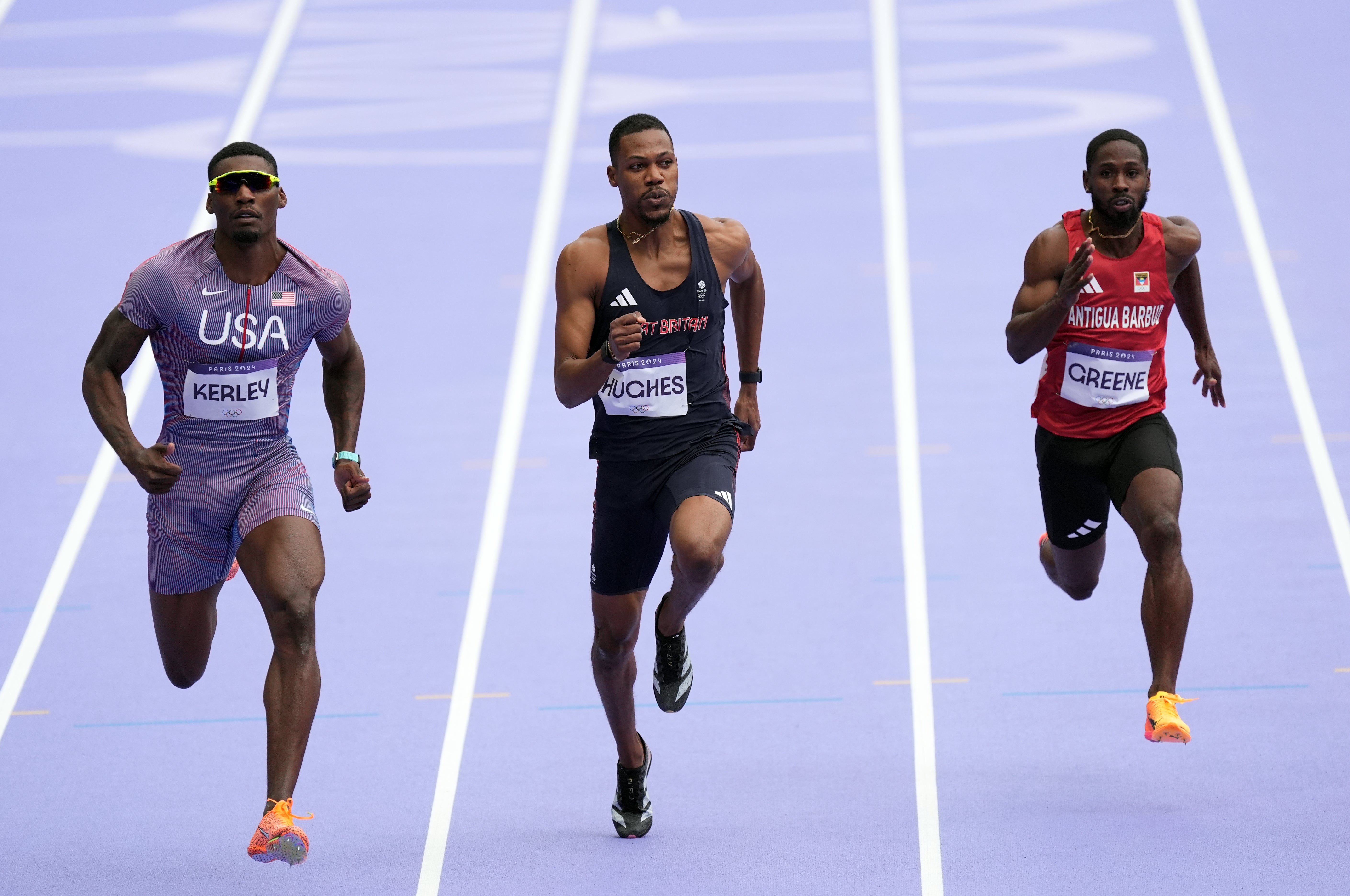 Great Britain’s Zharnel Hughes (centre) in action in men’s 100 metres heats at the Paris Olympics (Martin Rickett/PA).