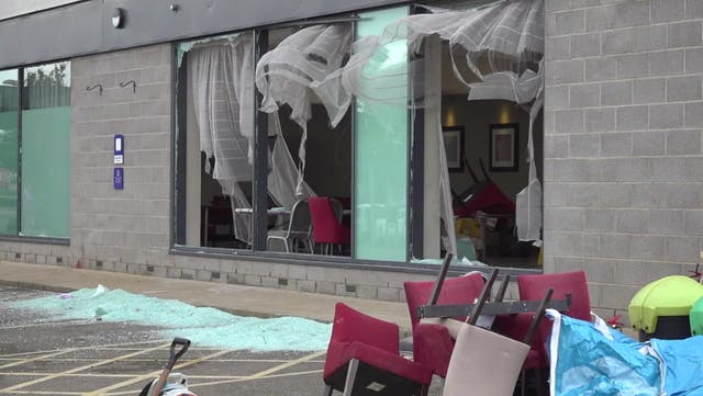 <p>Rotherham riots: Police guard Holiday Inn as residents sweep up glass in mammoth clean-up.</p>