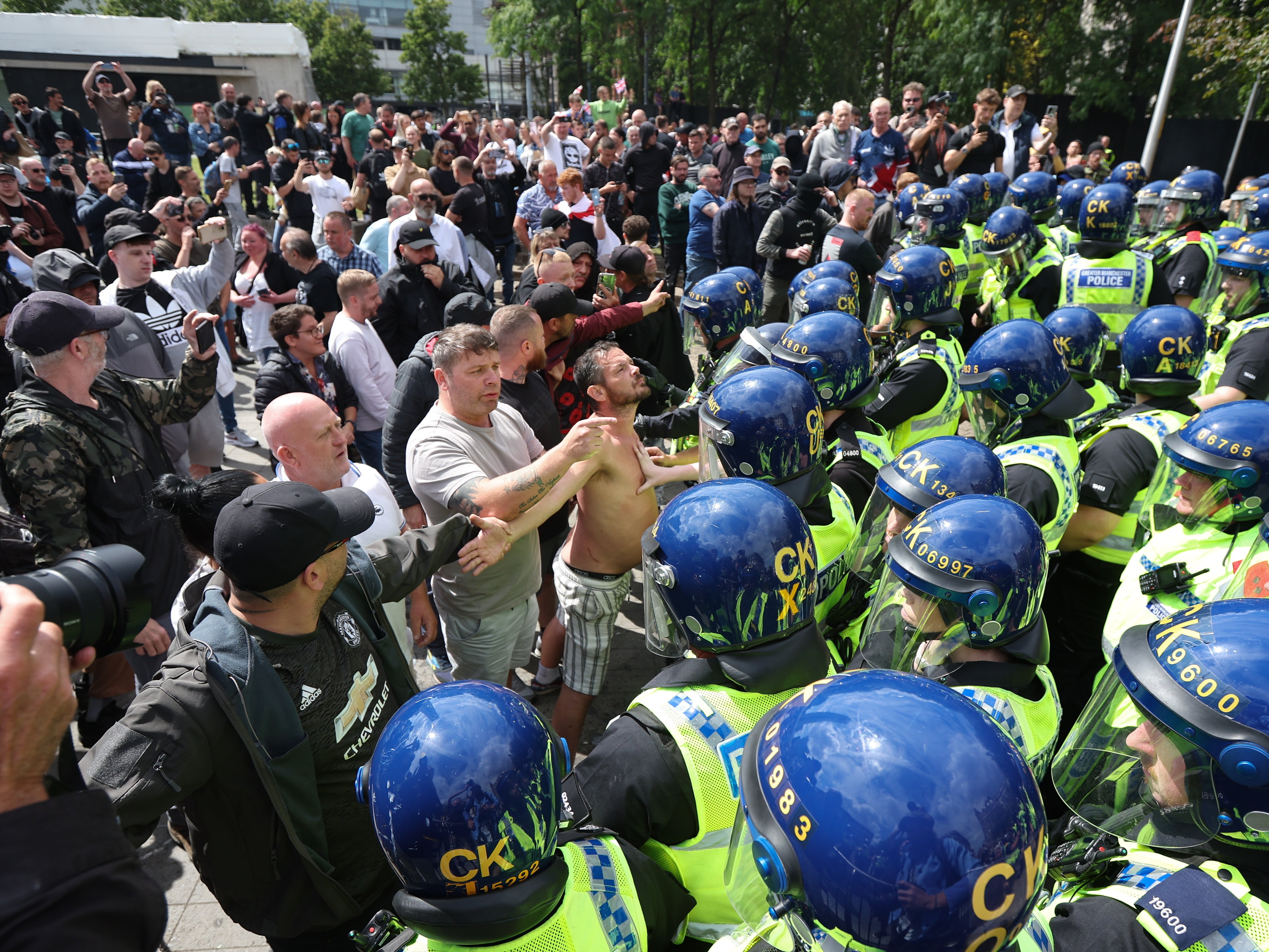 Far-right rioters clashing with police in Manchester