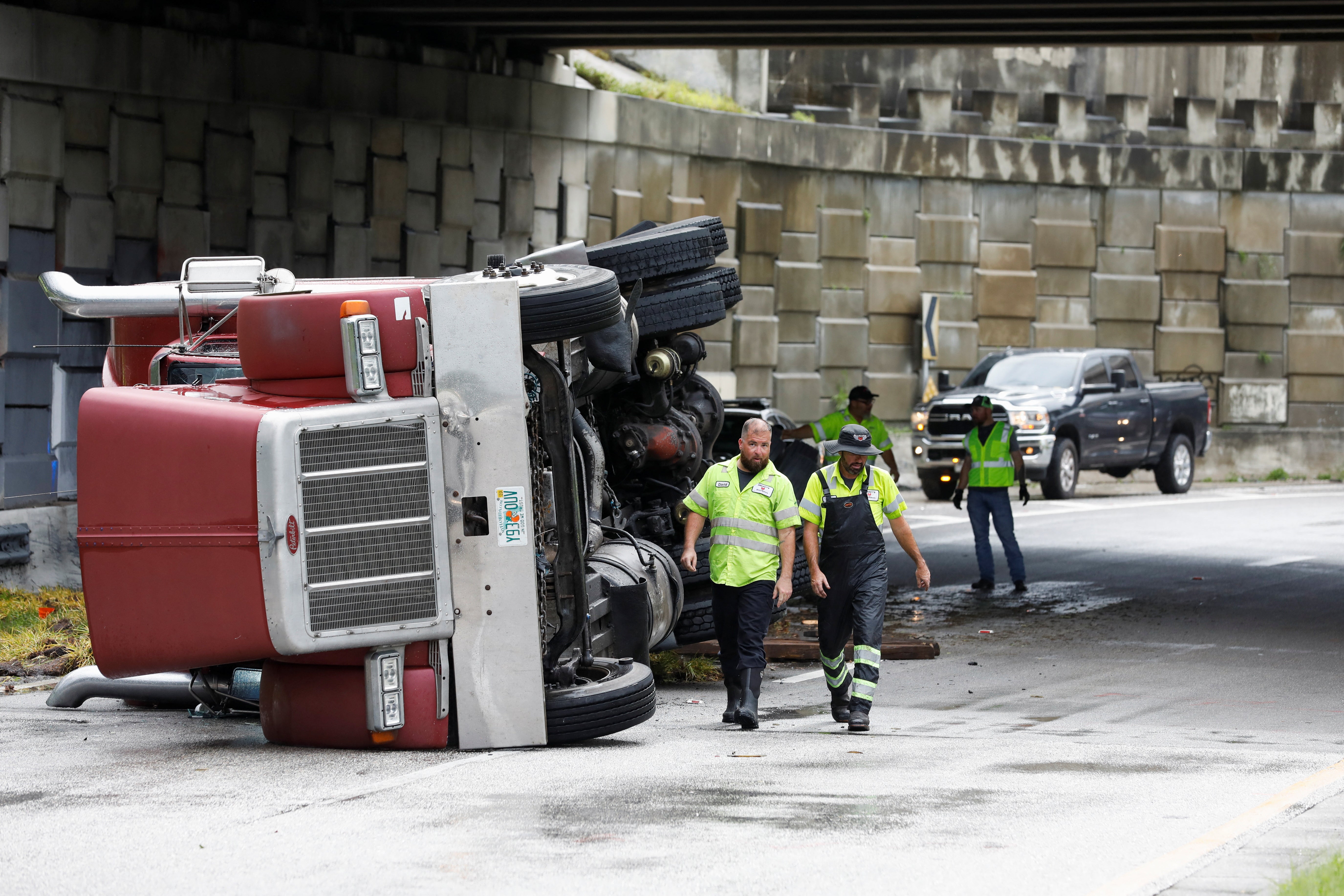 A transfer truck lies overturned on Independence Parkway in Tampa, as Hurricane Debby moves north of central Florida, August 5, 2024.