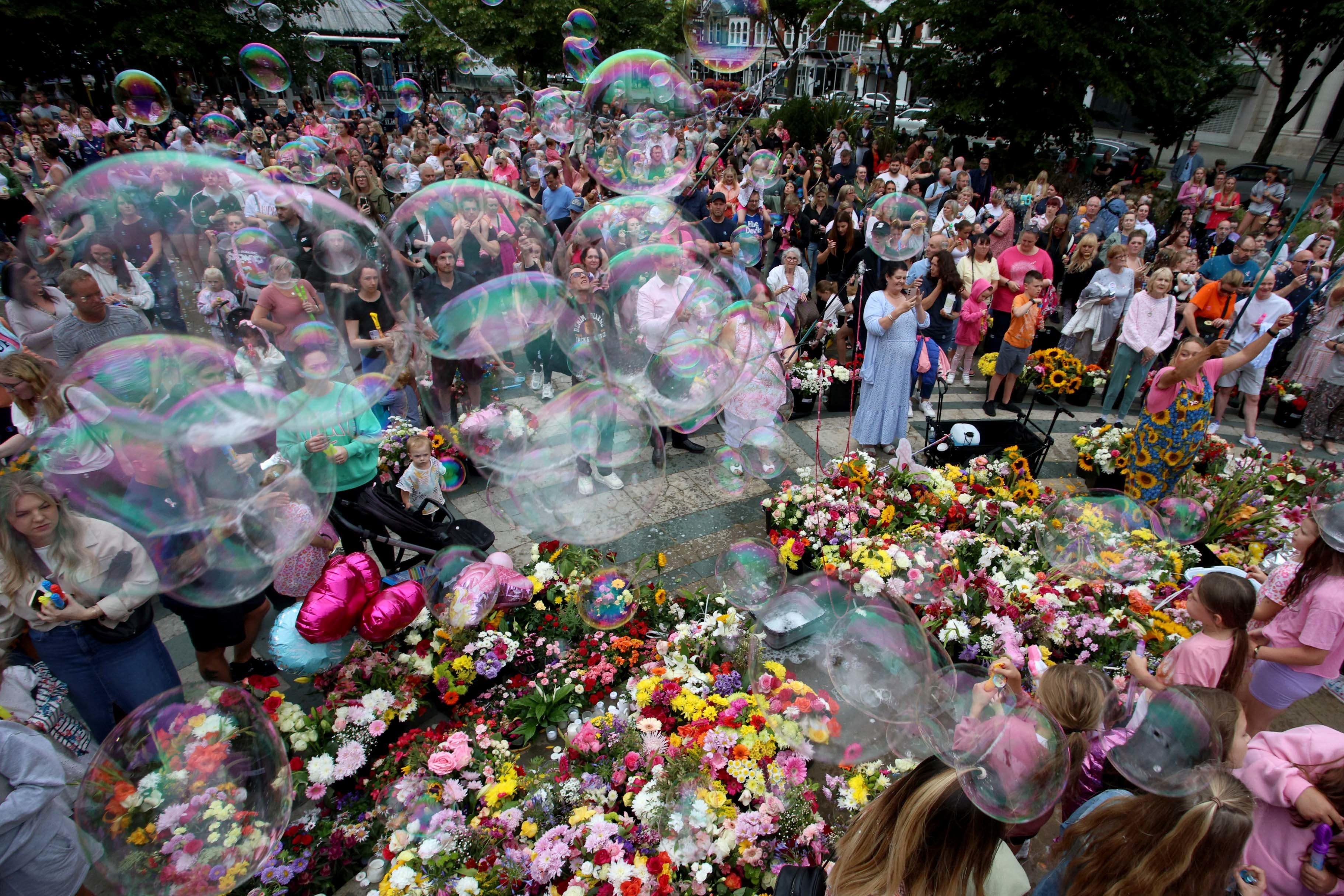 Members of the public take part in a vigil in Southport