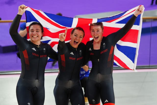 Great Britain’s Sophie Capewell, Katy Marchant and Emma Finucane (l-r) celebrate winning gold in the women’s team sprint at the Paris Olympics (David Davies/PA)