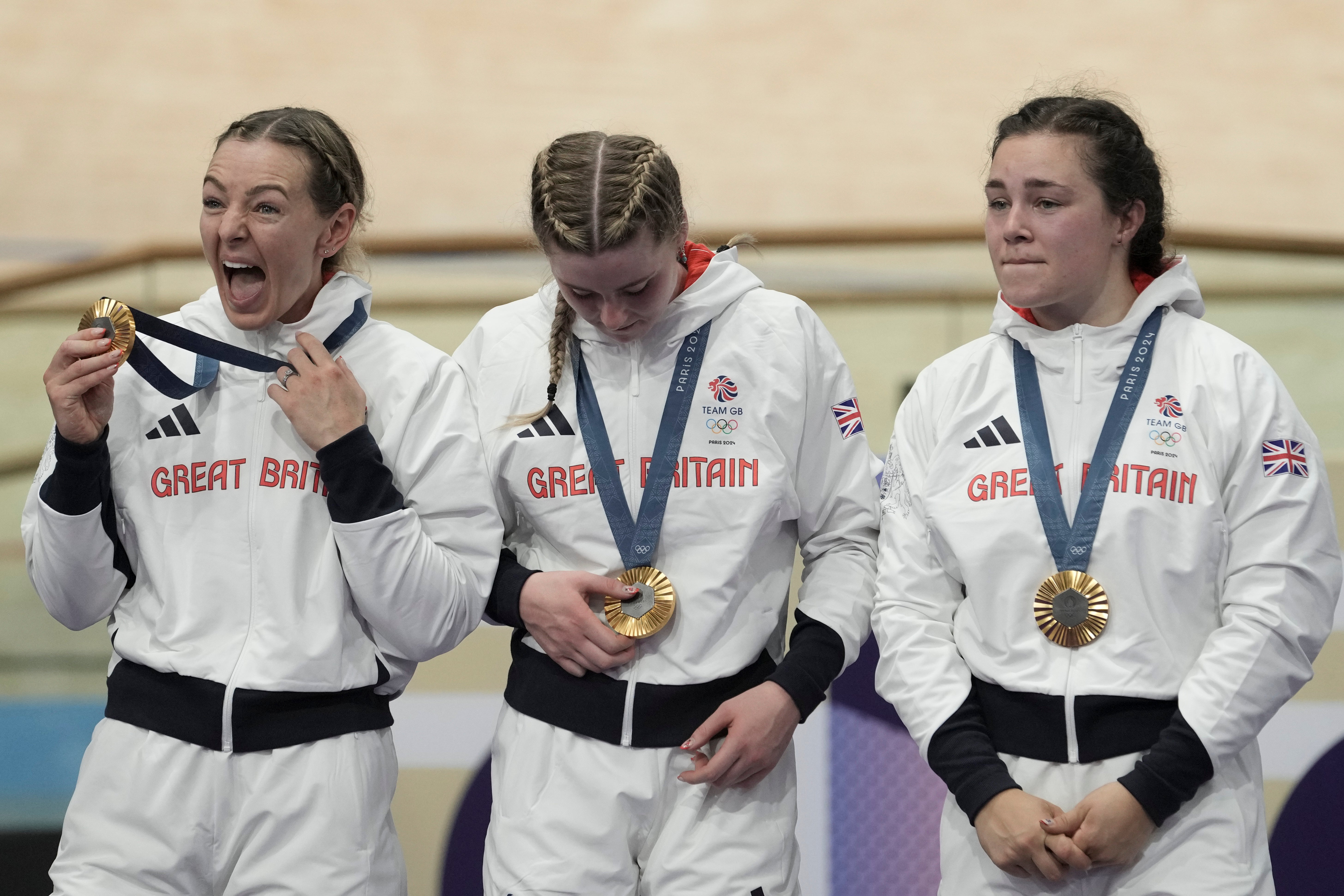 Britain’s Katy Marchant, Emma Finucane and Sophie Capewell celebrate on podium after winning the gold medal of the women’s team sprint event