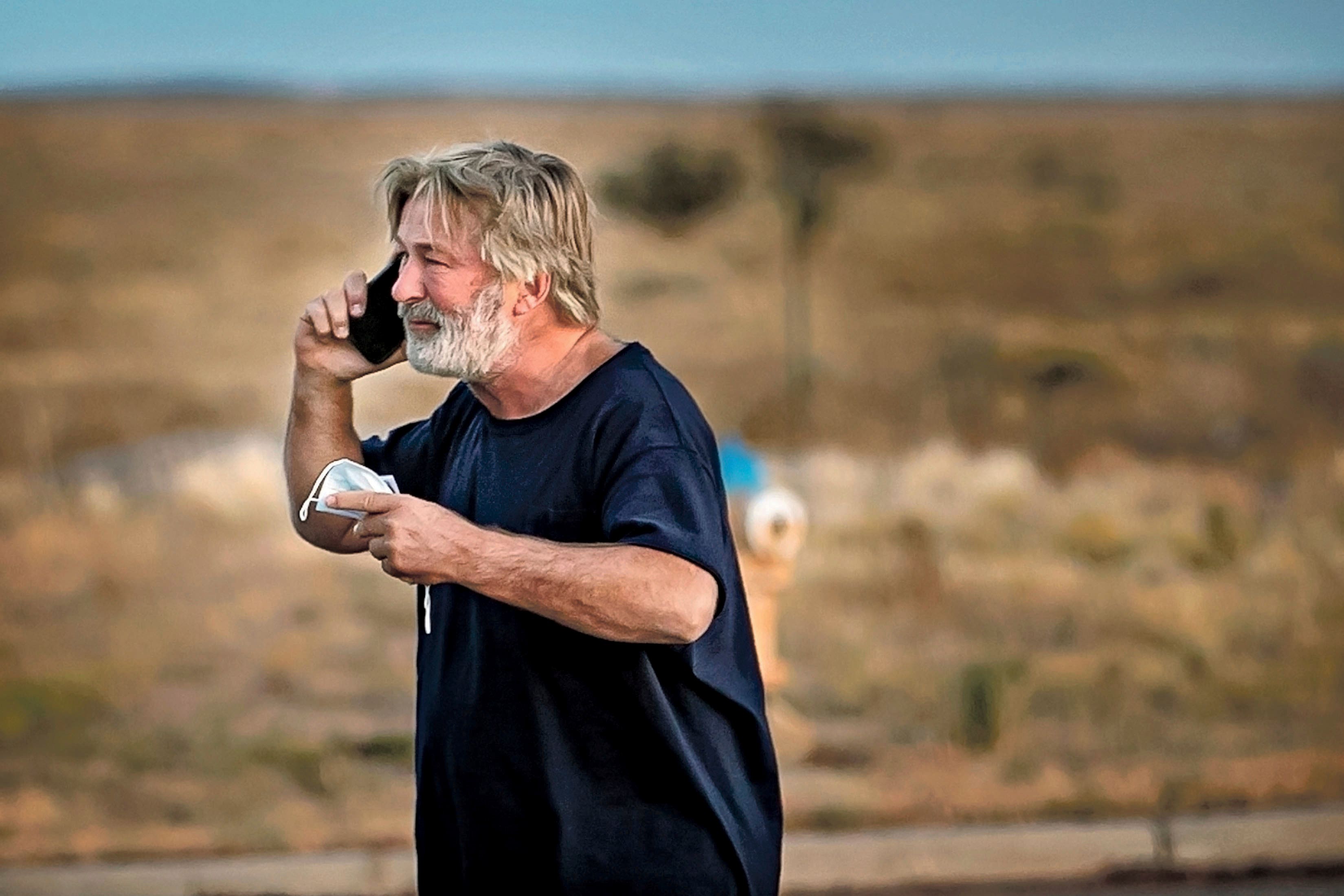 Alec Baldwin speaks on the phone in the car park outside the Santa Fe County Sheriff’s Office (Jim Weber/Santa Fe New Mexican via AP)