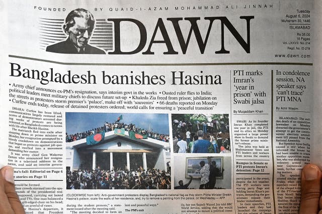 <p>A man reads the front page of a newspaper with an article on Bangladesh, in Islamabad a day after Sheikh Hasina was ousted by anti-government protesters </p>