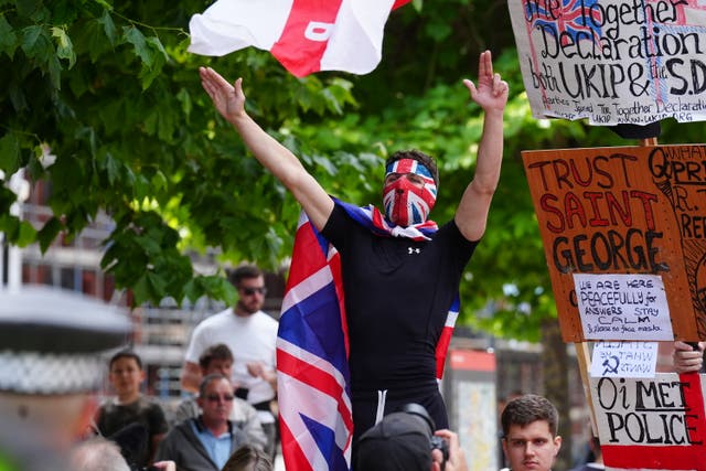 <p>A far-right protester wrapped himself in the flag in Leeds on Saturday </p>