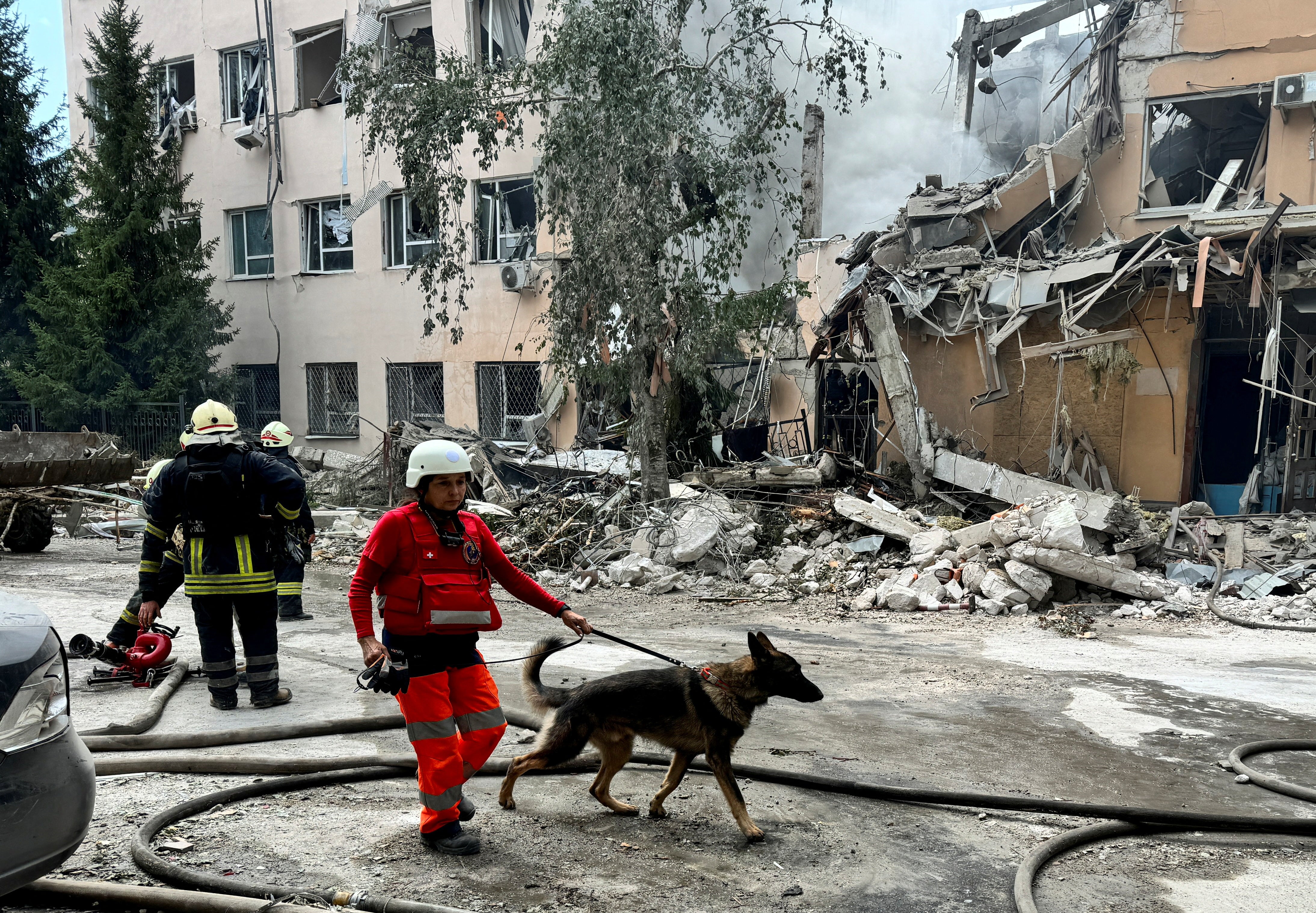 Rescue workers search for people under the rubble after a missile attack on Kharkiv, August 6