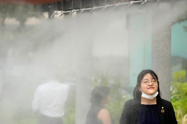 <p>People cool off at a cooling mist spot on July 4, 2024, in Tokyo </p>