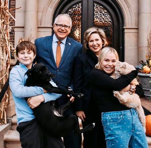 Minnesota Governor Tim Walz, posing with his wife, Gwen, daughter, Hope, and son, Gus, grew up in Nebraska, joined the Army National Guard and taught high school before pursuing a political career