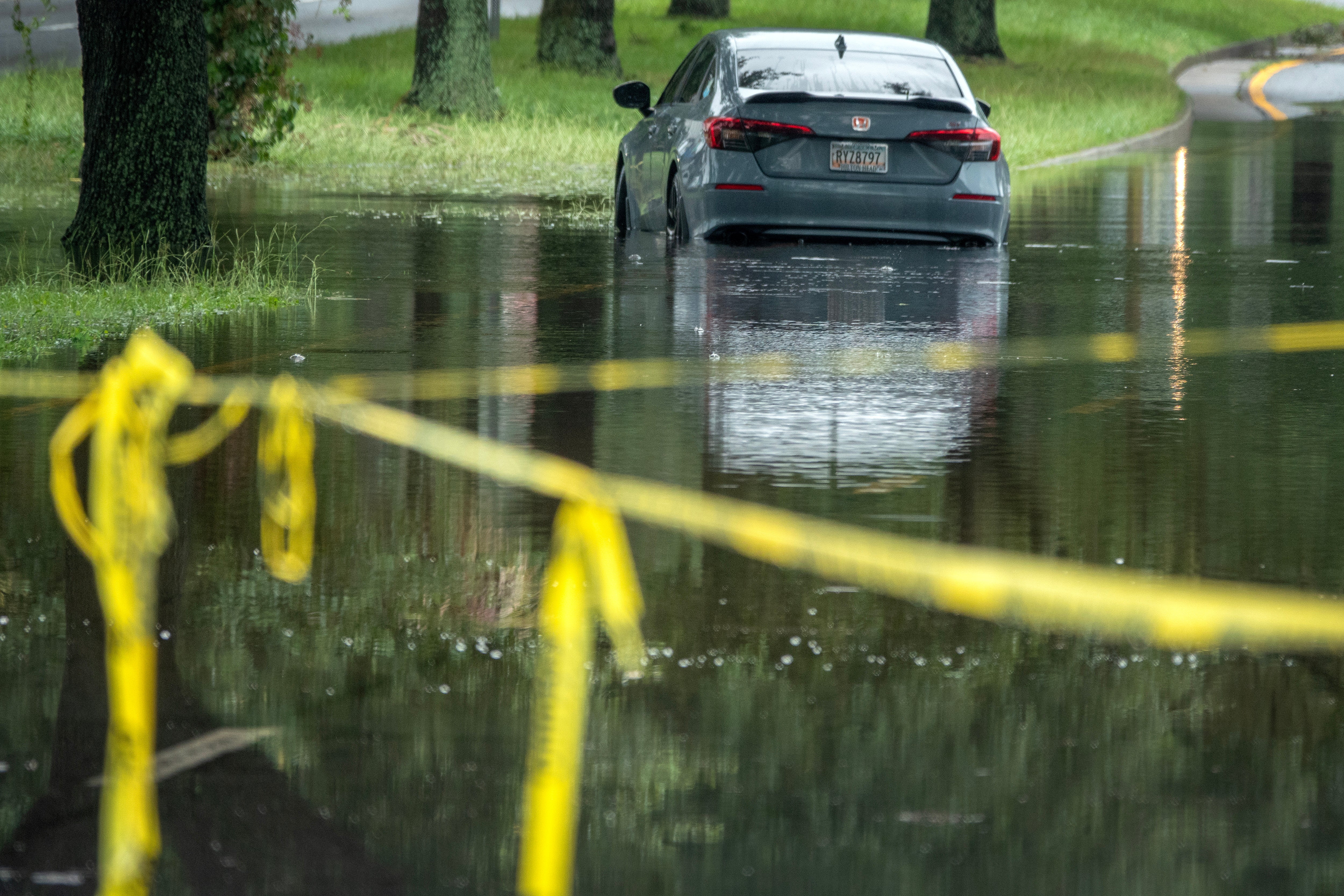 A car sits stuck in flooded water in Savannah, Georgia on Tuesday