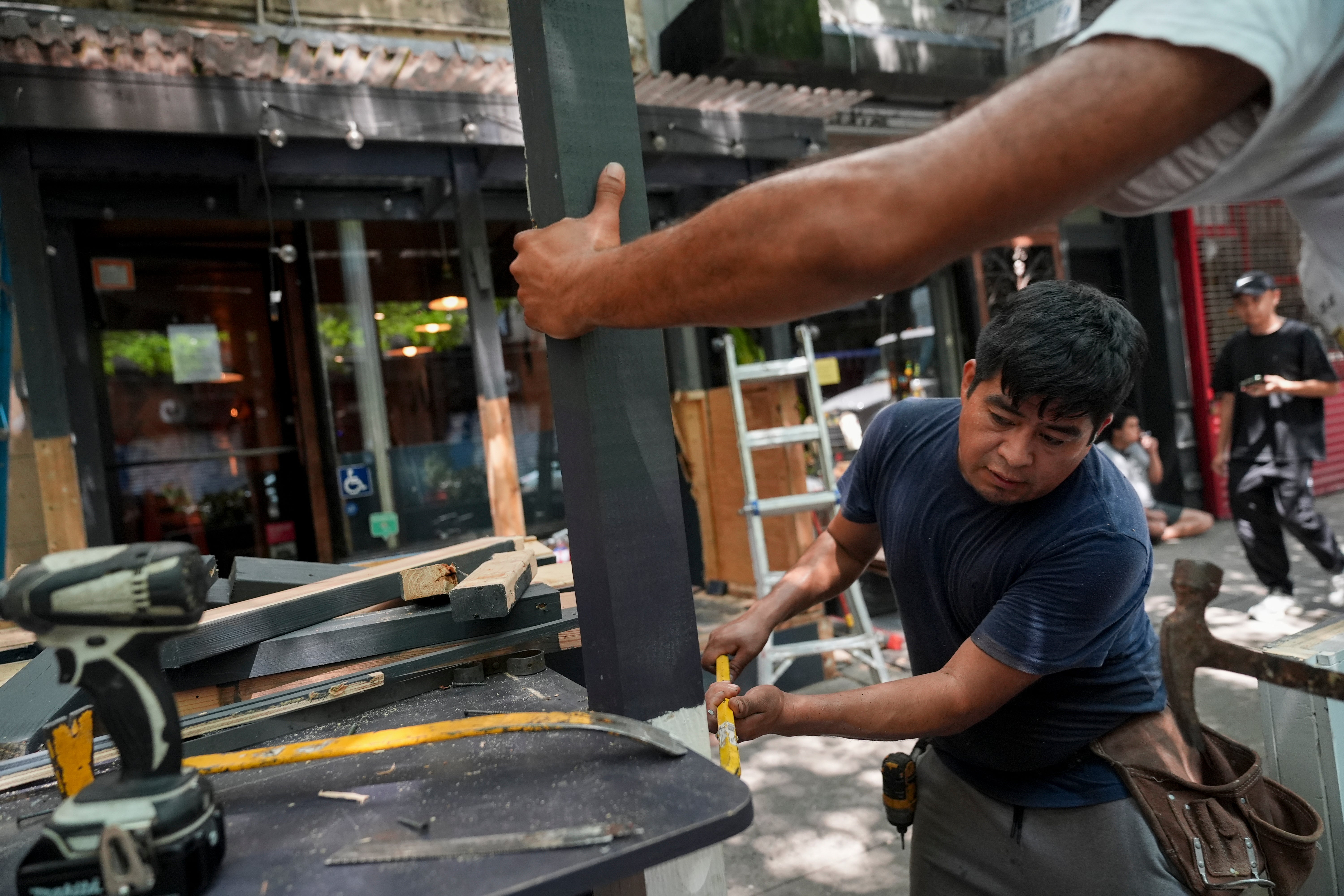 Workers demolish the outdoor dining shed attached to Ruffian Wine Bar, Thursday, Aug. 1, 2024, in New York. The final day for restaurants to register for Dining Out NYC, a new city program regulating outdoor dining spaces, went into effect on August 3, but fewer than 3,000 restaurants in the city are participating