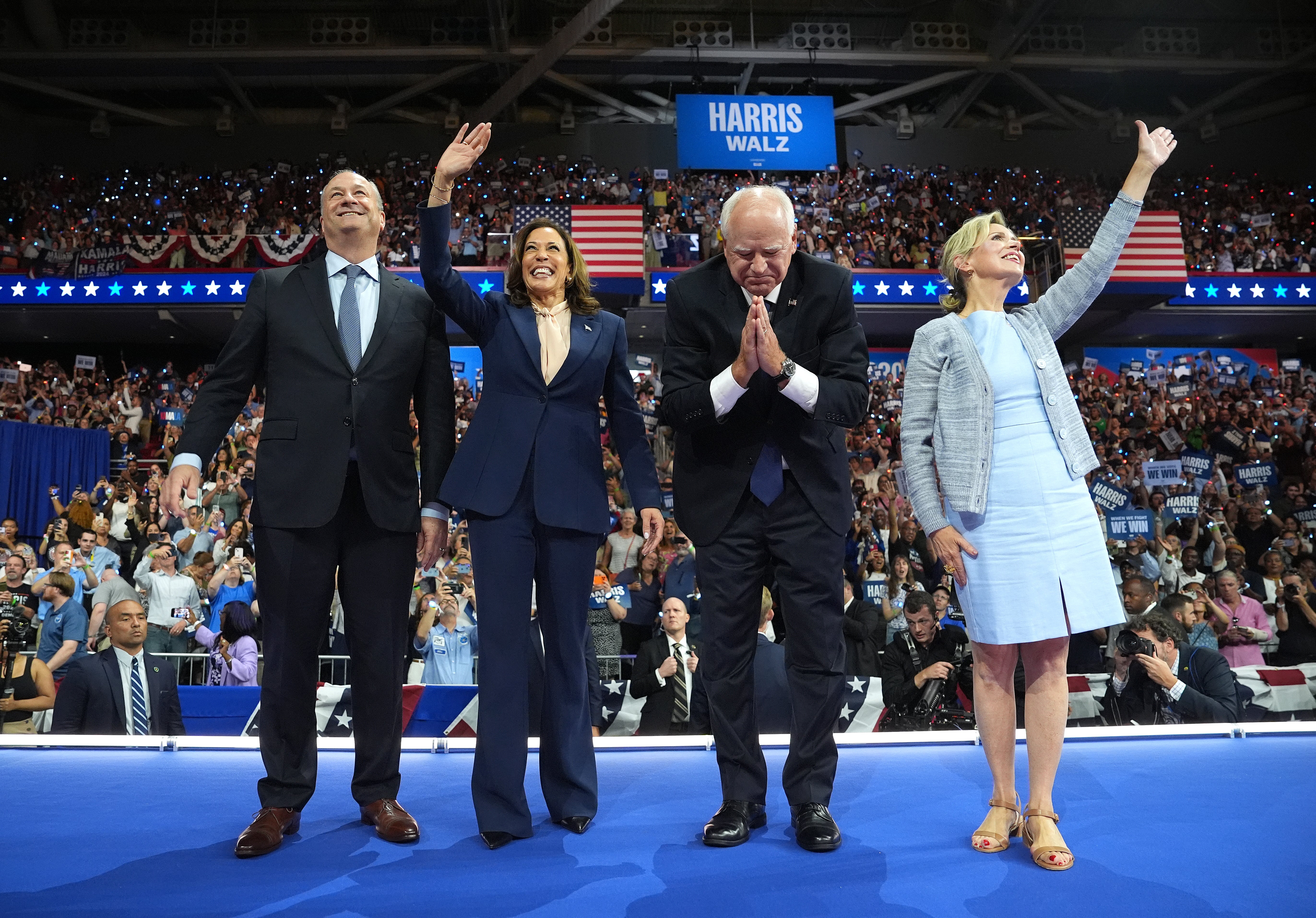 Second gentleman Doug Emhoff, Vice President Kamala Harris, Minnesota Governor Tim Walz and his wife Gwen Walz greet supporters at a campaign rally in Philadelphia on August 6.