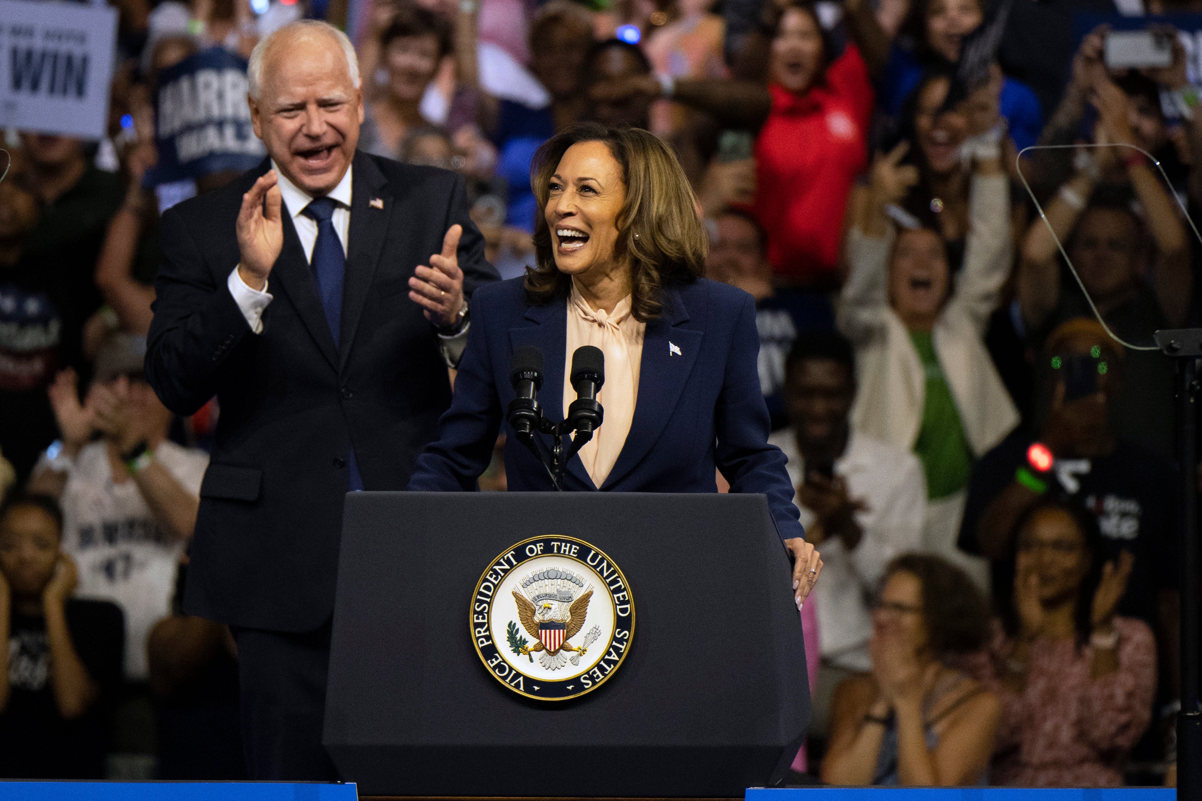 Harris is applauded by Walz during her address