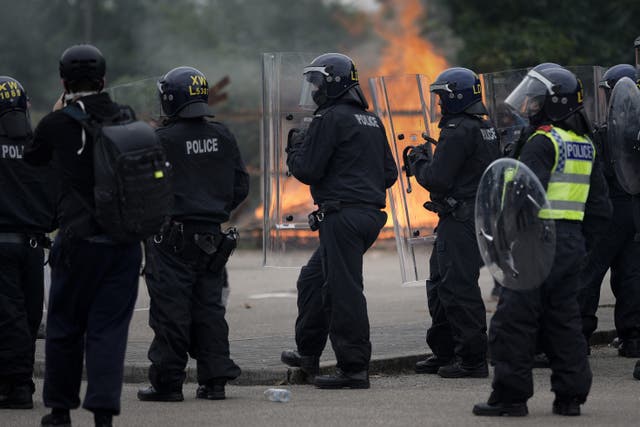 <p>Police dealing with rioters during the incident outside Holiday Inn Express in Rotherham </p>