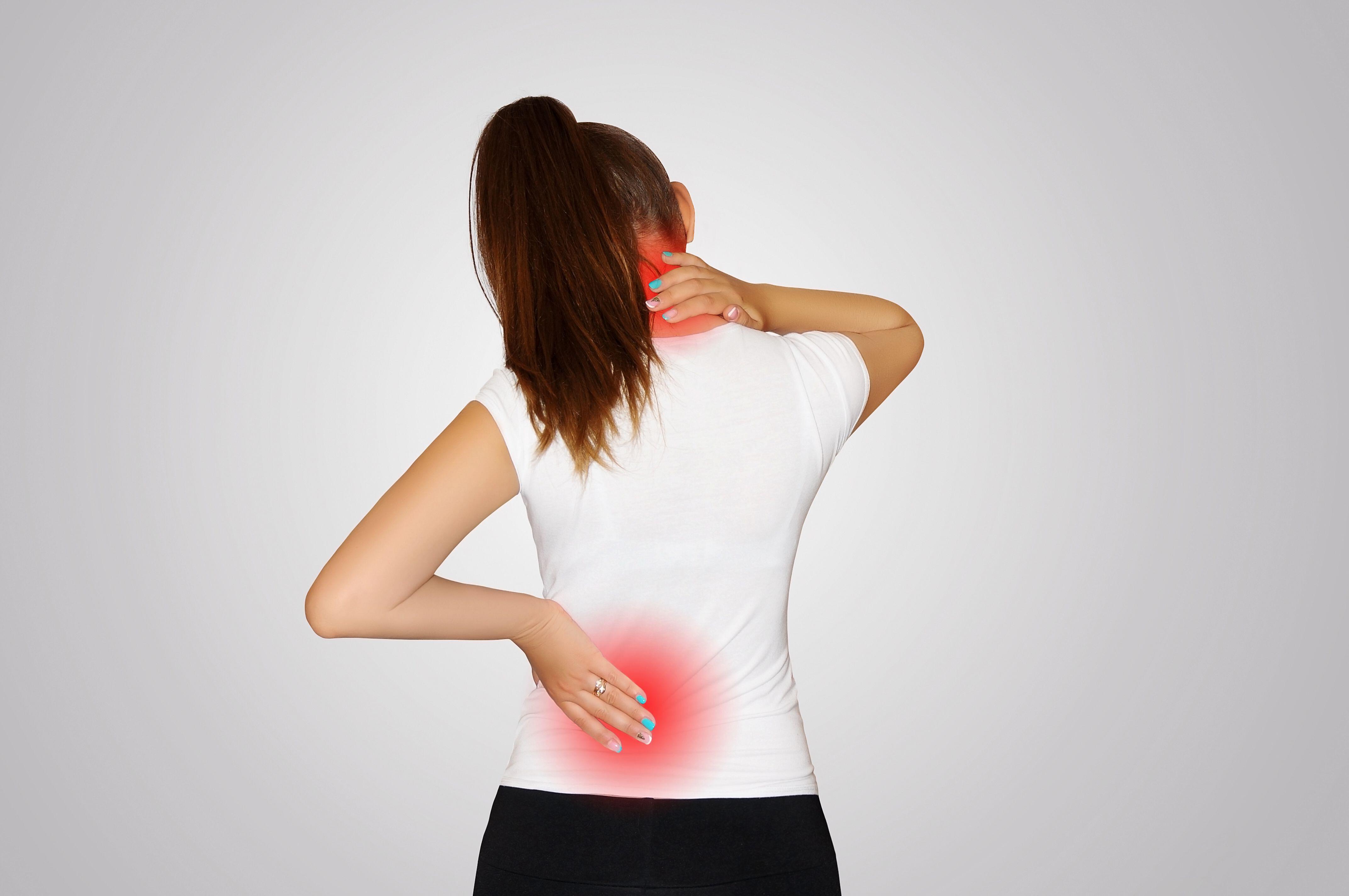 Young woman suffering from back and shoulder pain (Alamy/PA)