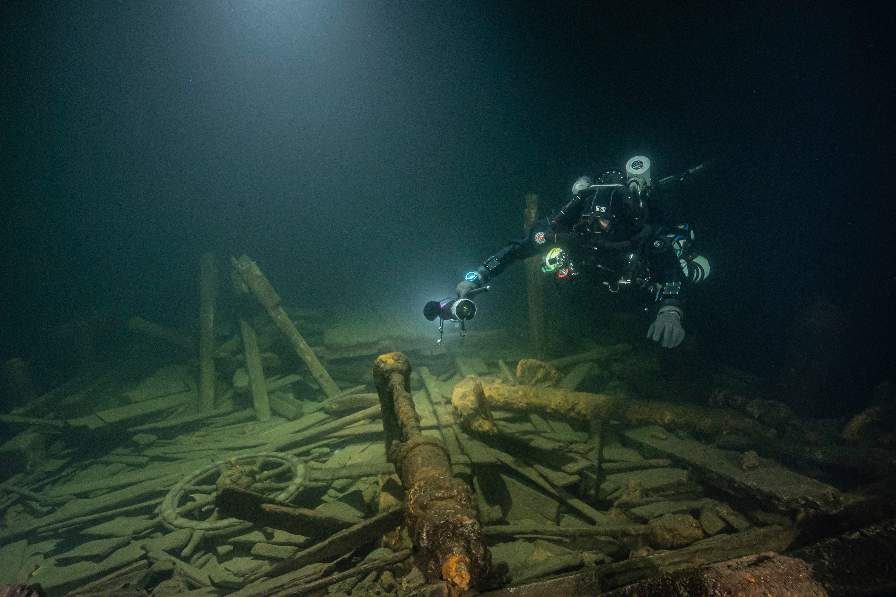 A diver from the Polish Baltictech team inspects wreckage of a 19th century sailing ship that the team discovered July 1