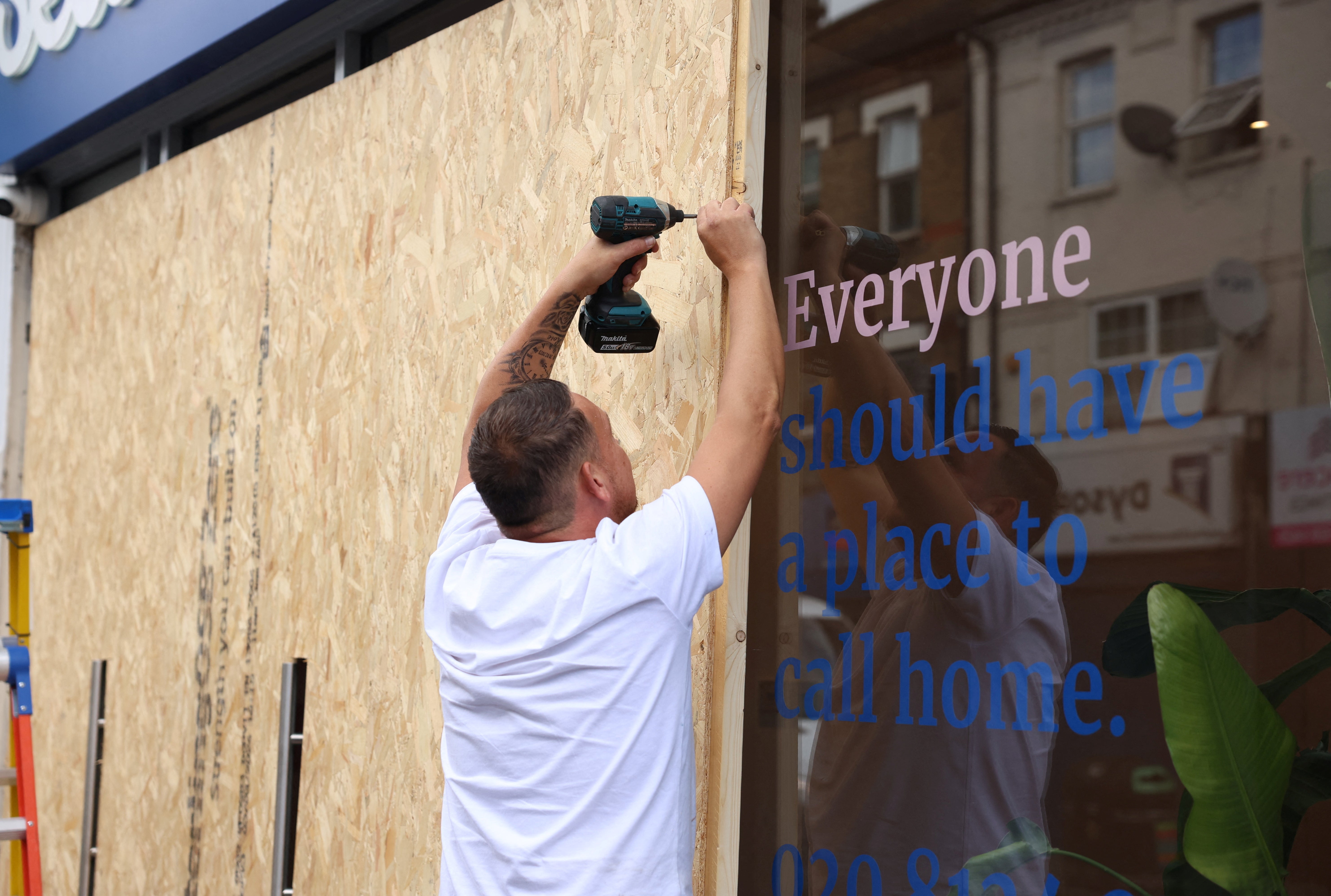 An immigration bureau in London is boarding up its windows amid fears of further clashes on Wednesday