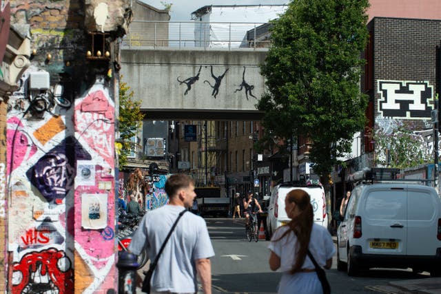 Silhouette of three monkeys underneath a railway bridge (Banksy/Instagram/PA)