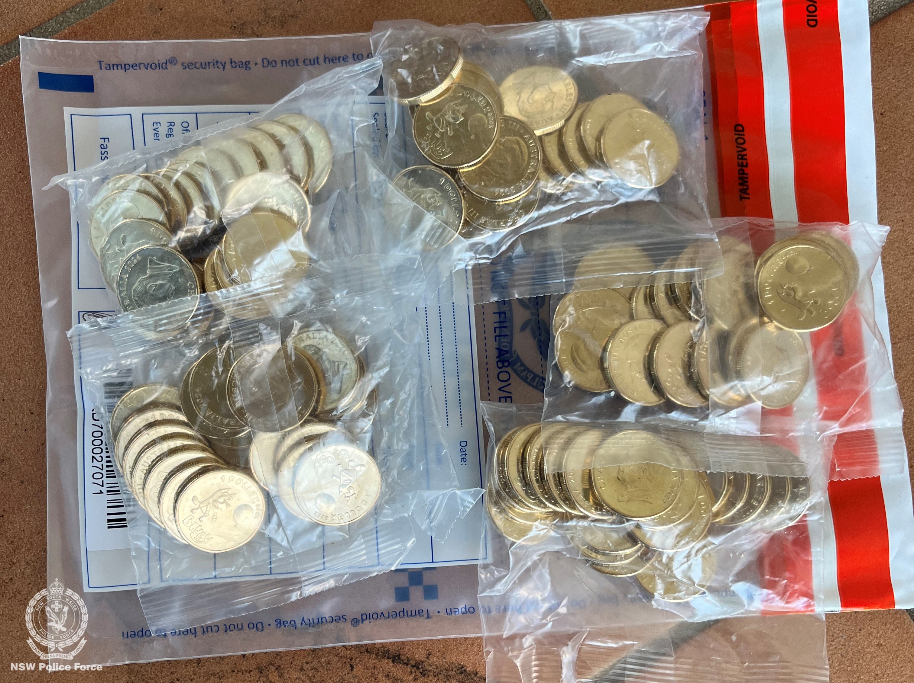 Bags of commemorative Bluey coins were seized by police