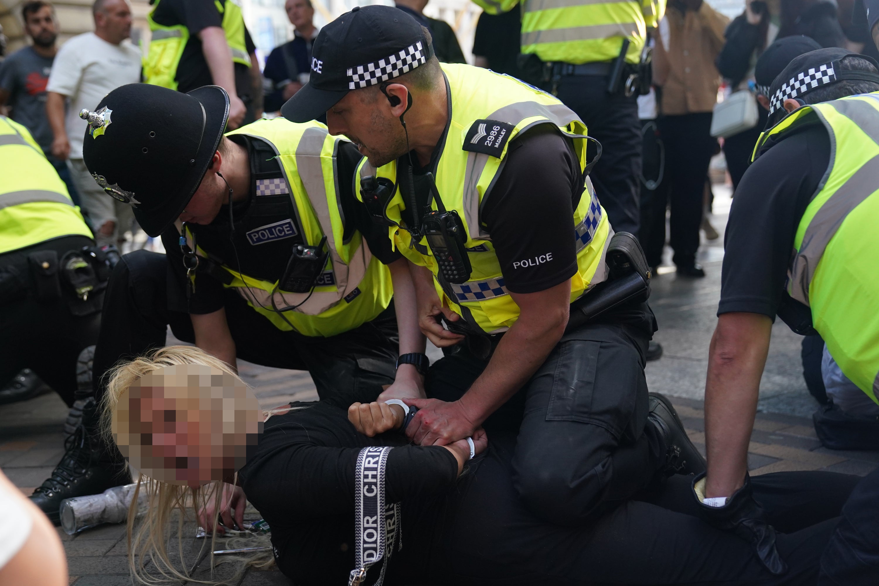 A woman is restrained during disorder in Nottingham