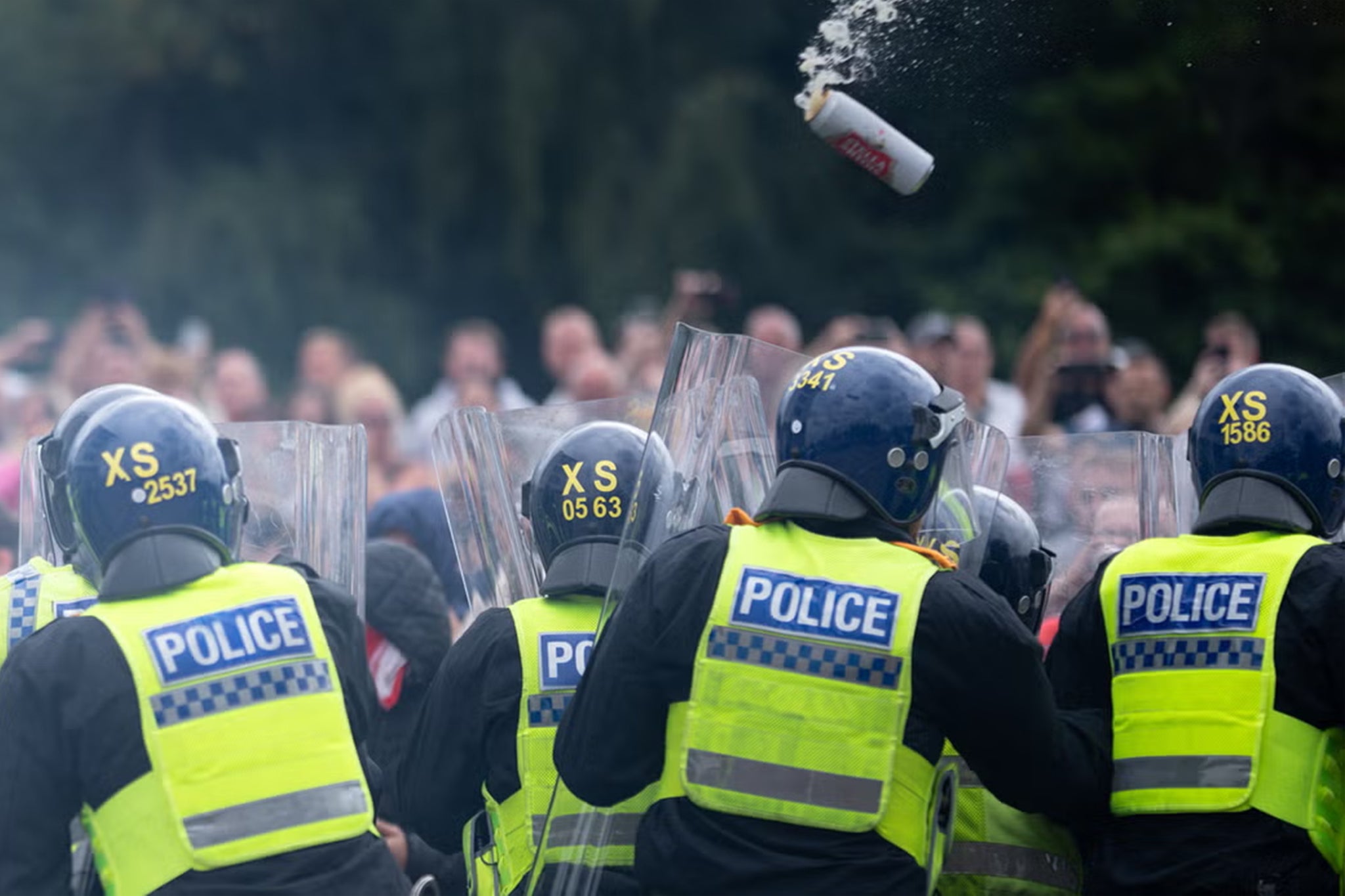 Police officers push back rioters with shields outside the Holiday Inn Express Hotel in Rotherham