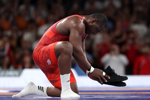 <p>Mijain Lopez left his shoes in the ring as a signal of his retirement from Greco-Roman wrestling </p>