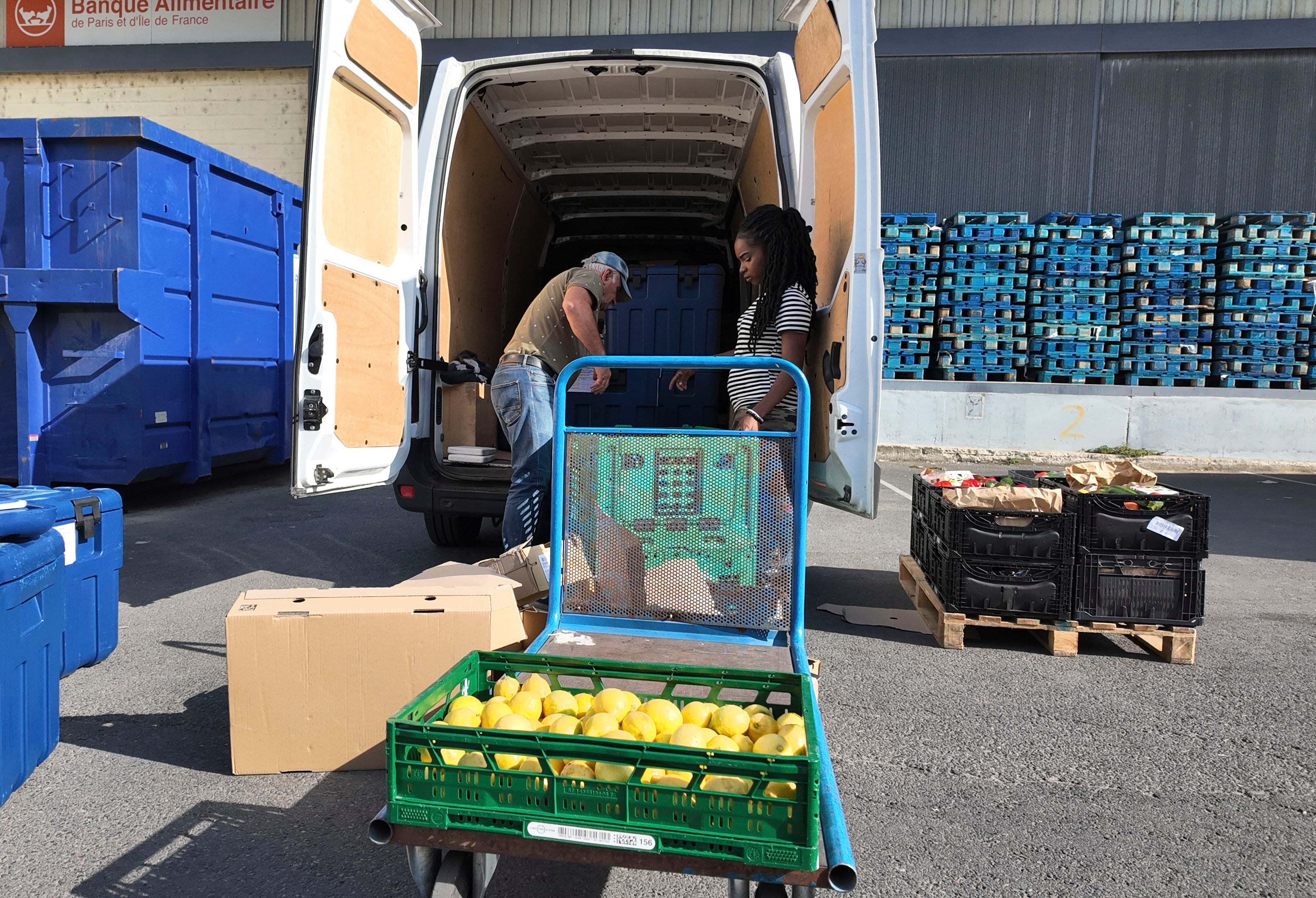 A volunteer uploads goods into a vehicle for food distribution, during the 2024 Summer Olympics, in Gennevilliers, France. Los Angeles has started hiring for its 2028 summer games