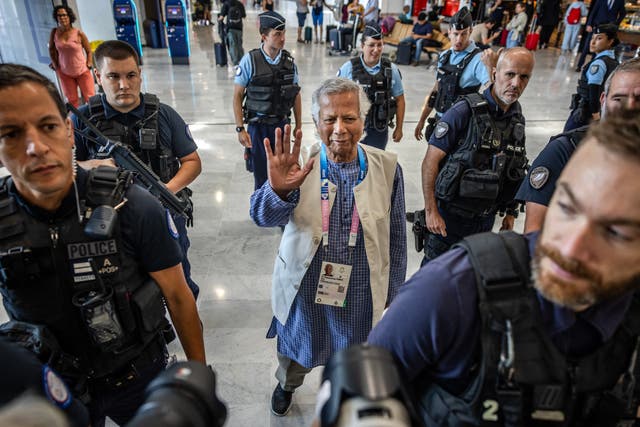 <p>Muhammad Yunus is escorted by French police at Charles de Gaulle airport in Paris on Wednesday enroute to Bangladesh</p>