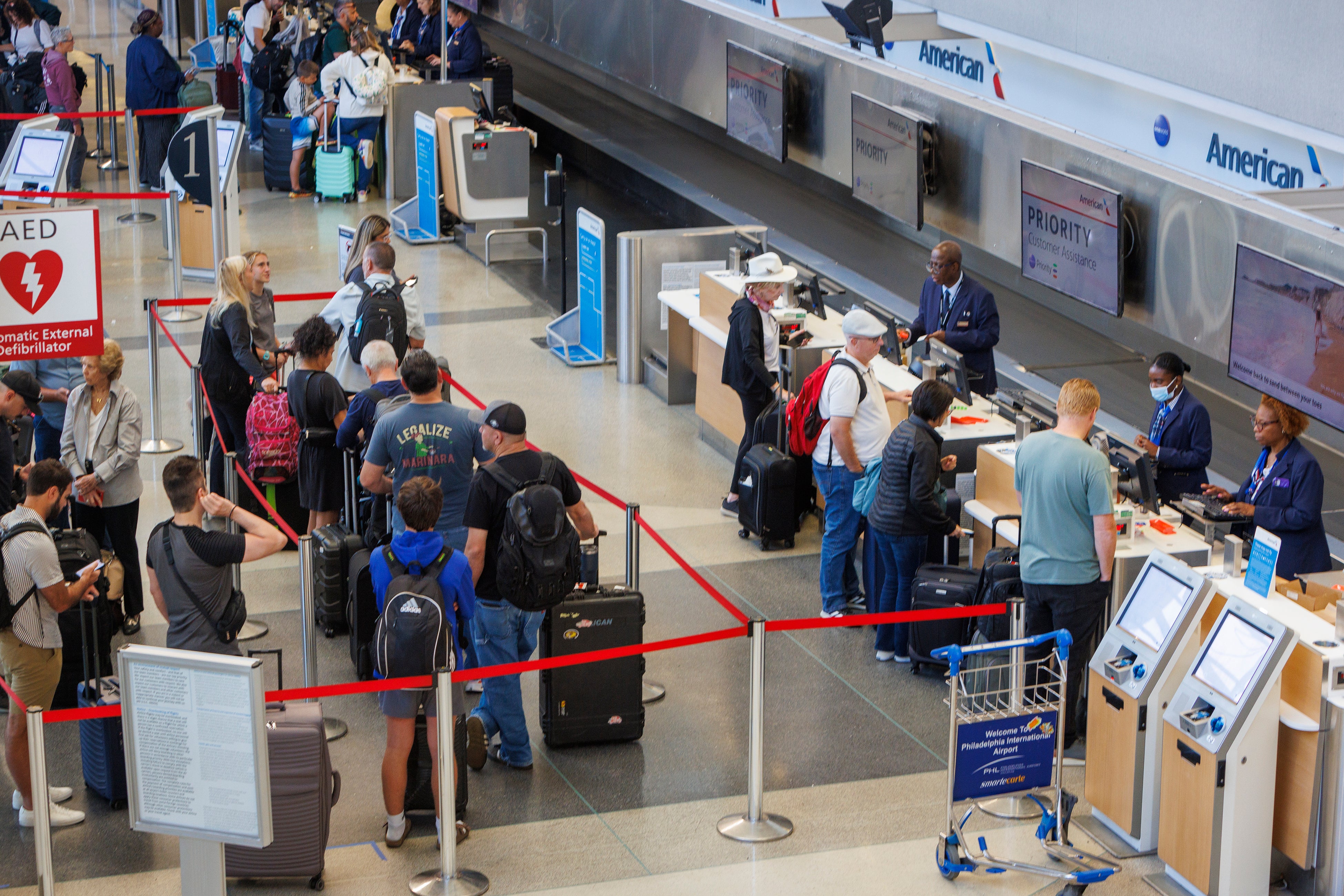 Passengers wait in line at the Philadelphia International Airport on Monday as Tropical Storm Debby causes flight delays across the East Coast