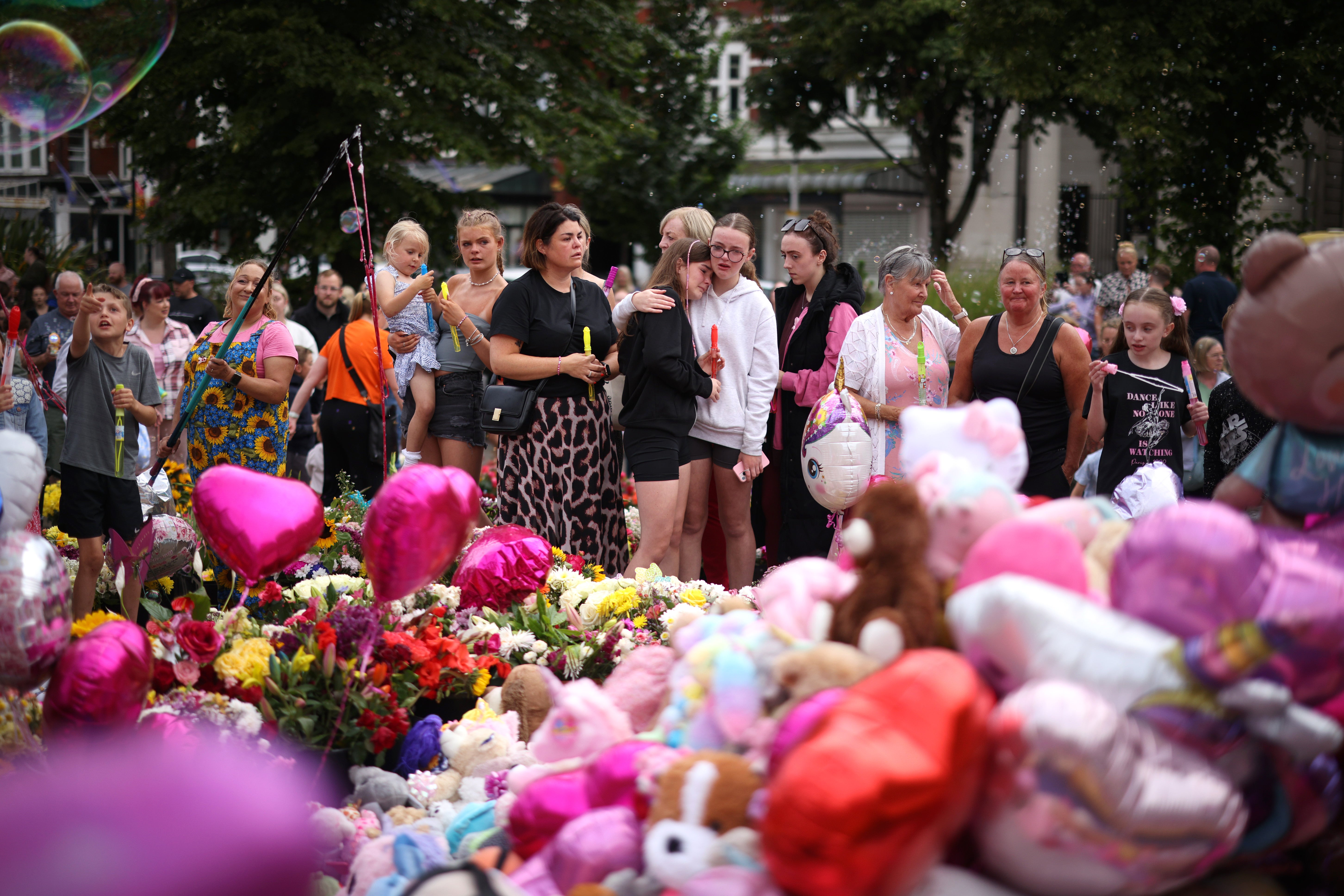 People gather at a vigil to mourn the three children killed in a stabbing at a Taylor Swift-themed dance class in Southport, UK