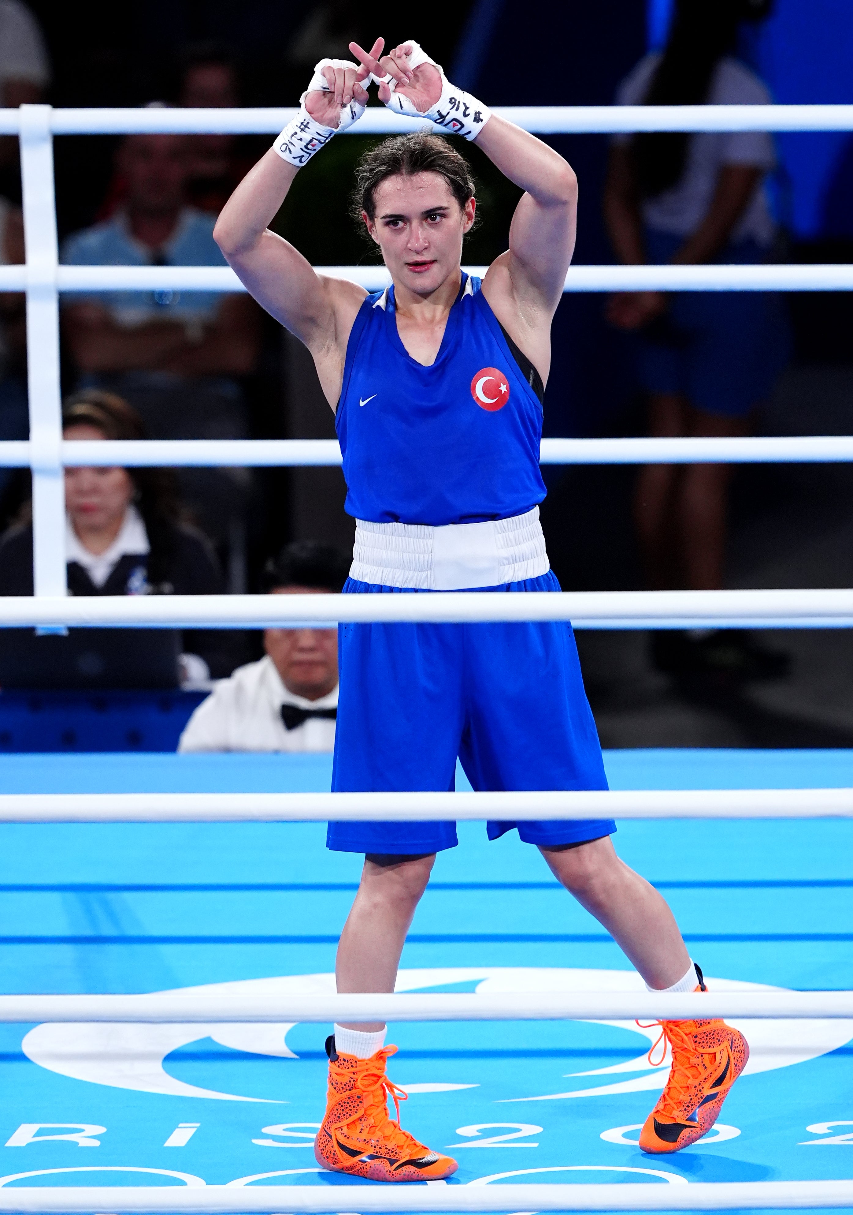 Turkey's Esra Yildiz Kahraman does an 'X' sign with their hands