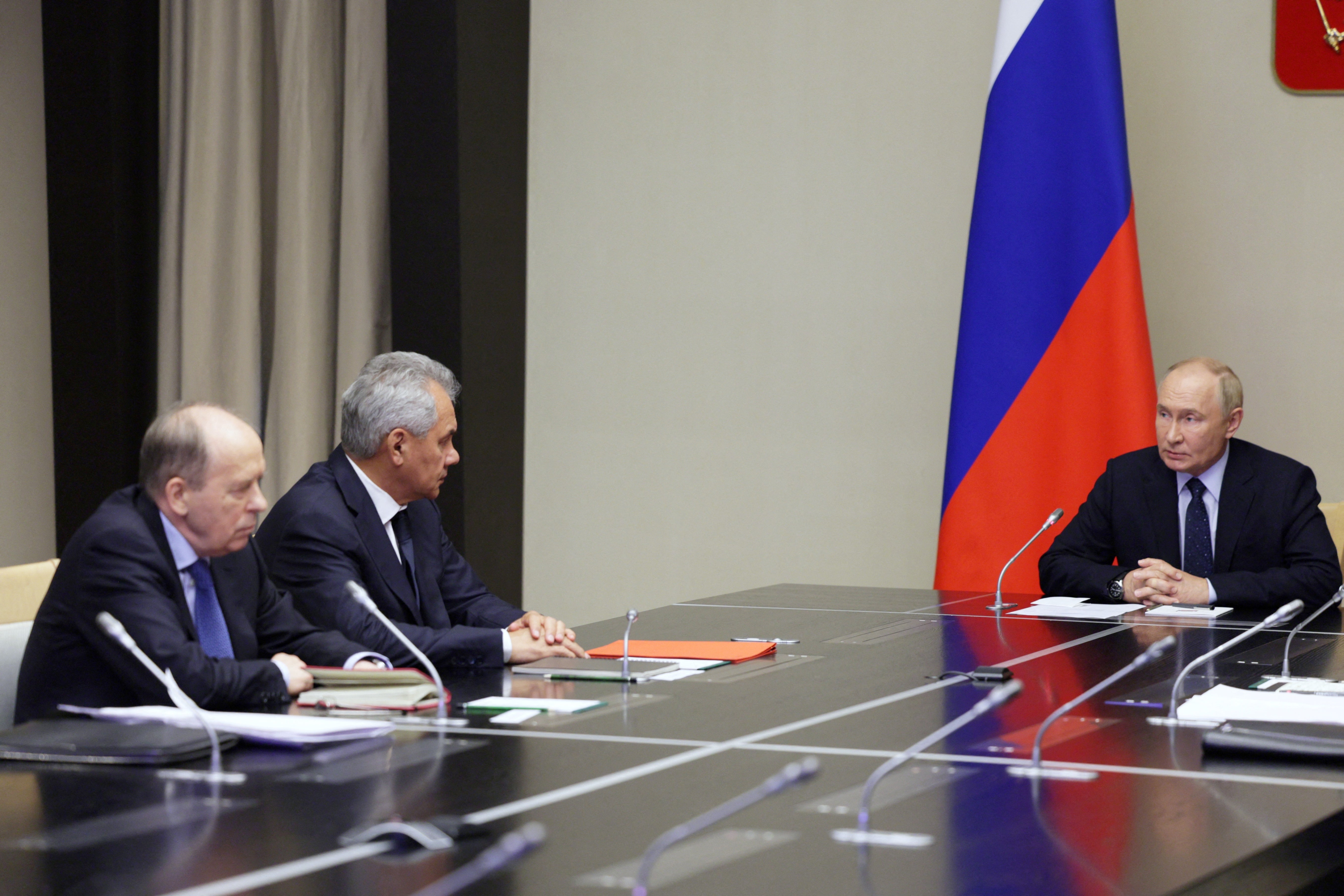 Putin (R) holds a meeting with heads of law enforcement agencies on the situation in the Kursk region