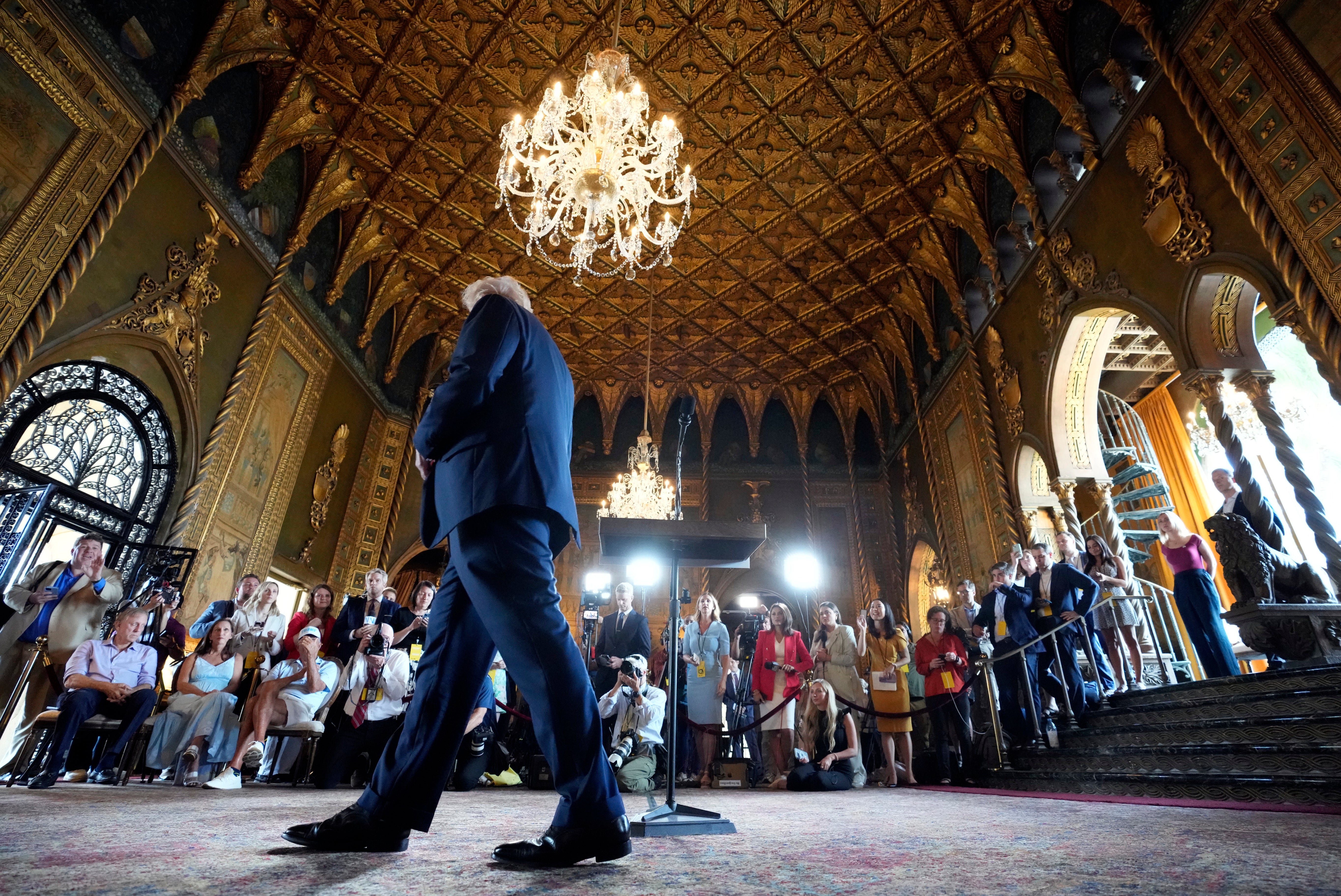 Trump leaves his press conference at Mar-a-Lago on Thursday where he claimed his crowd size rivalled that of MLK Jr