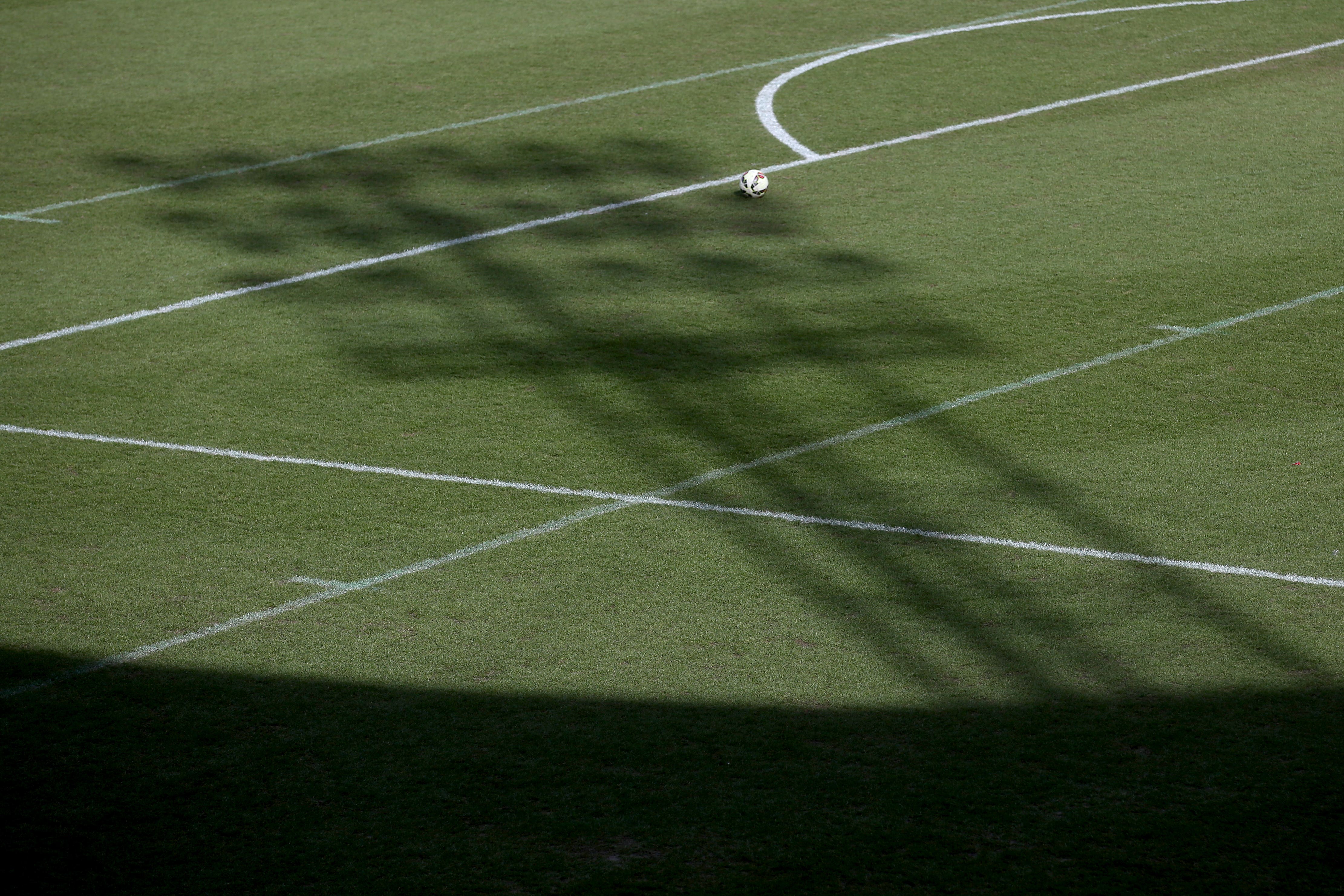 The shadow of a floodlight on the pitch (Tim Goode/PA)