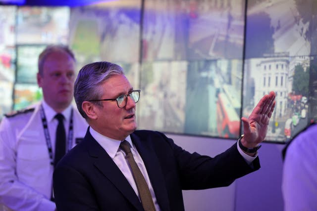 Keir Starmer views CCTV screens in the Engineering Suite in the Metropolitan Police Command and Control Special Operations Room (Toby Melville/PA)