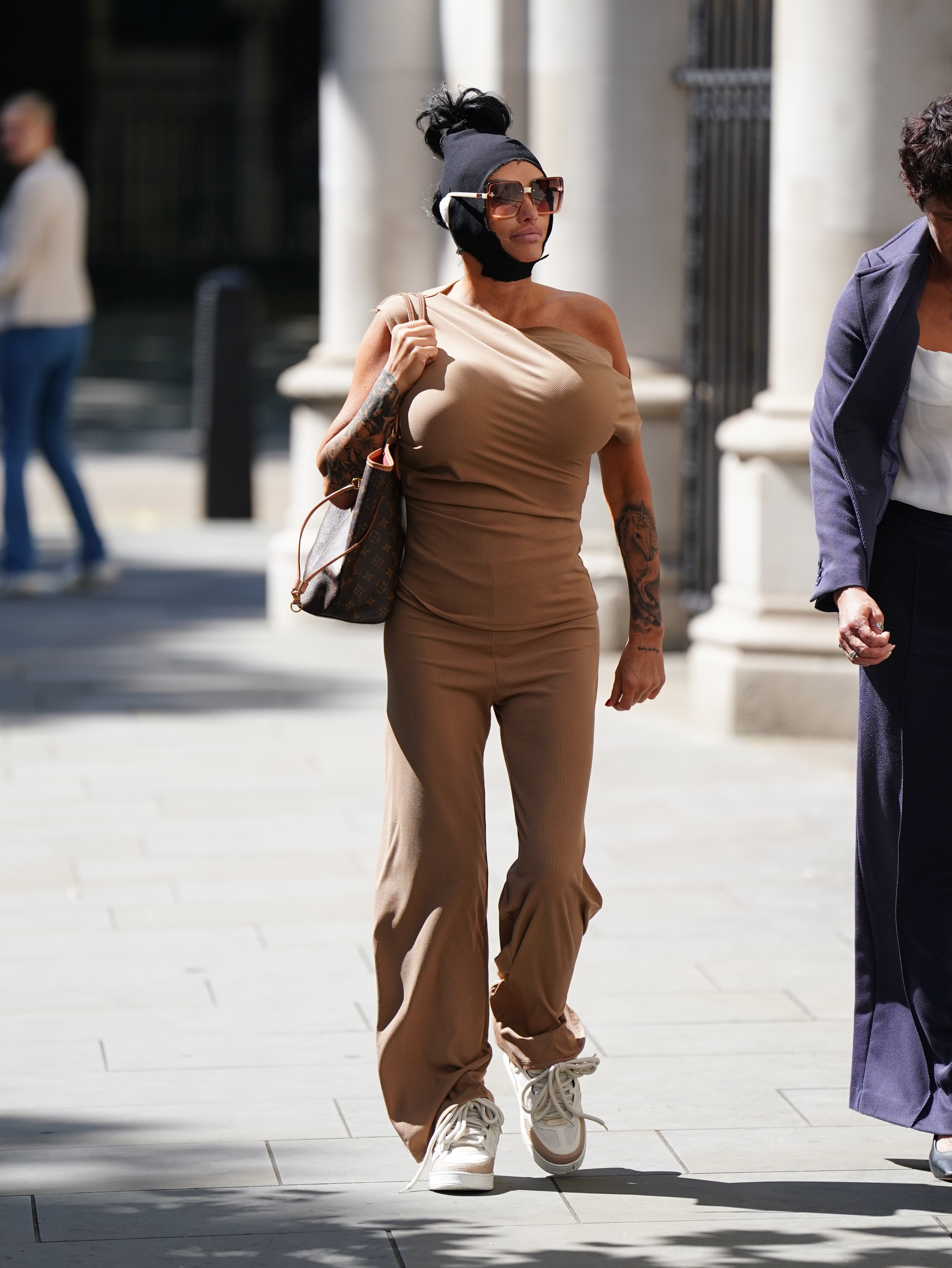 The former glamour model arriving in court on Friday