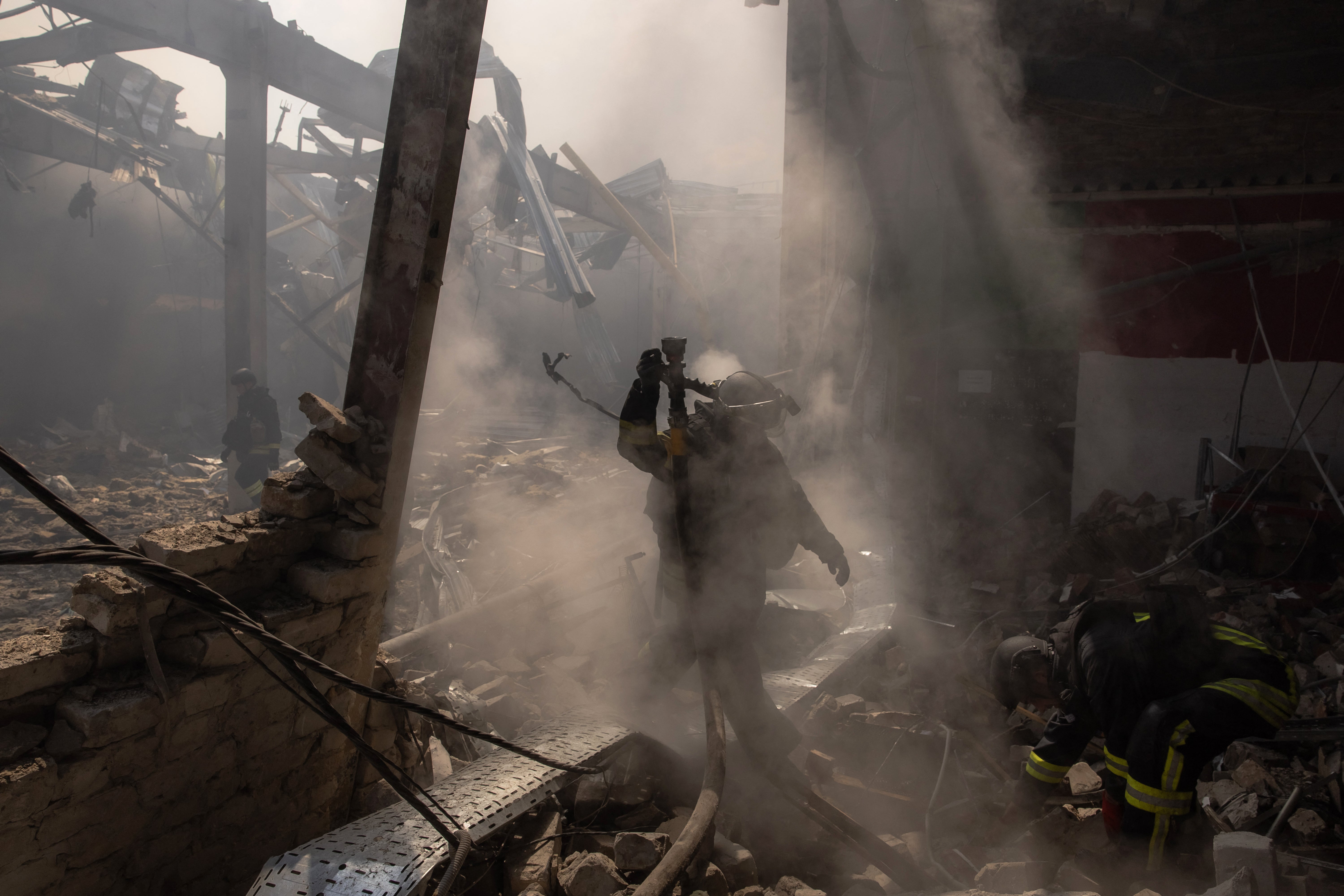 A Ukrainian emergency and rescue personnel stands among the rubble as they work at the site of the destroyed supermarket after a Russian attack in Kostiantynivka, eastern Donetsk region, on August 9, 2024, during the Russian invasion of Ukraine.