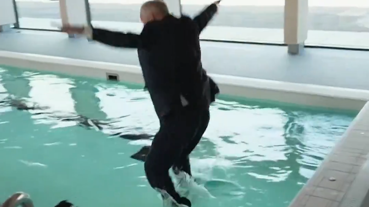 Reporter goes for gold as he dives into pool fully-clothed on live TV