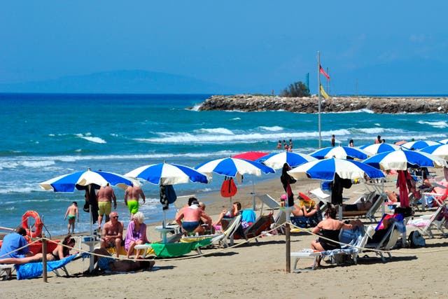 <p>People enjoy a sunny day at an establishment on the beach in Tuscany’s Castiglione della Pescaia, Italy</p>