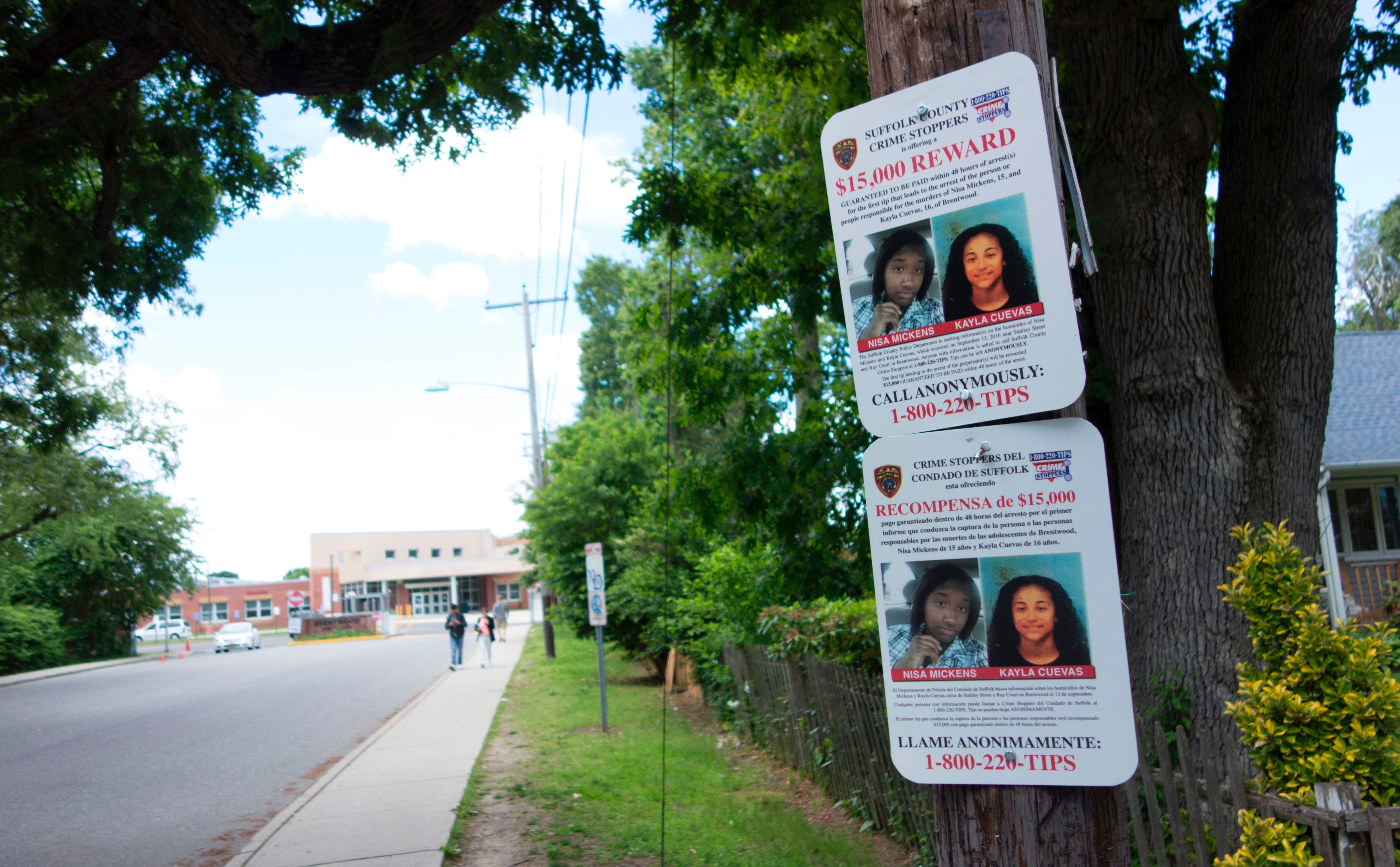 Reward poster hangs on a telephone pole asking for help in finding the killers of Kayla Cuevas nd Nisa Mickens