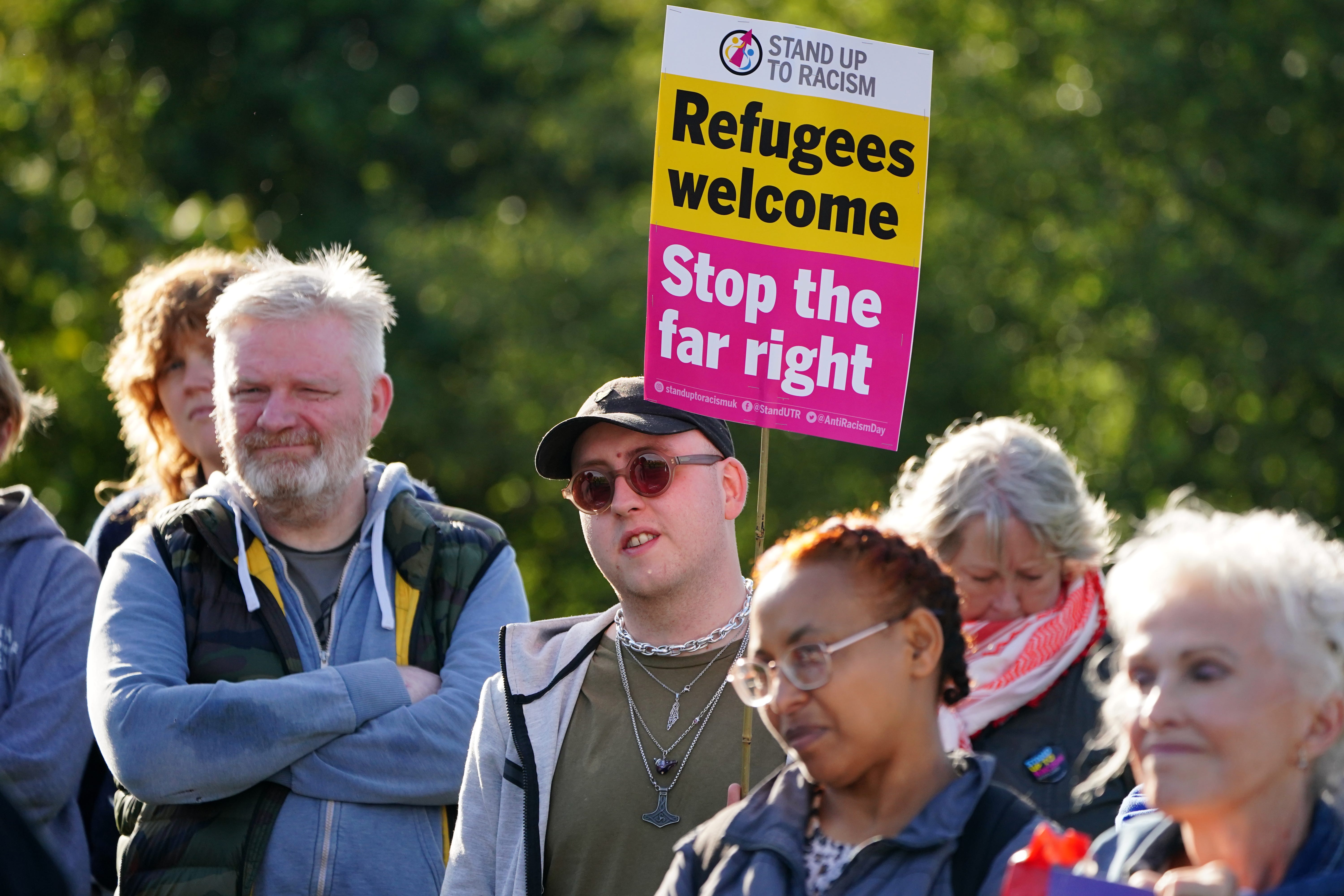 Demonstrators during an anti-racism protest organised by Stand Up to Racism, outside the Cairn Hotel in Bathgate (PA)