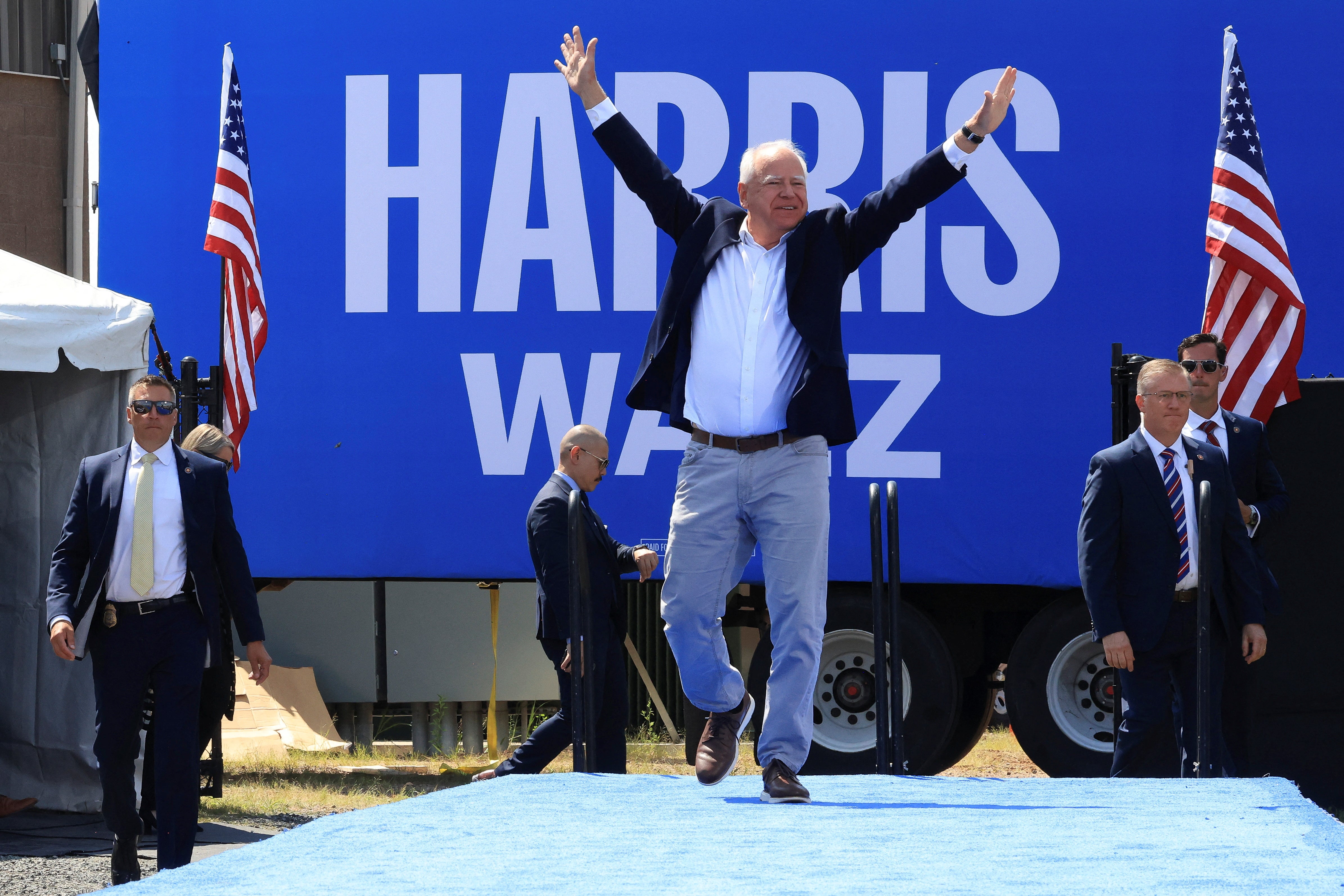 Vice Presidential candidate, Minnesota Governor Tim Walz, gestures during a campaign event in Eau Claire, Wisconsin. For some voters, Walz is a reminder of their own dad - before they were lost to political divisions.