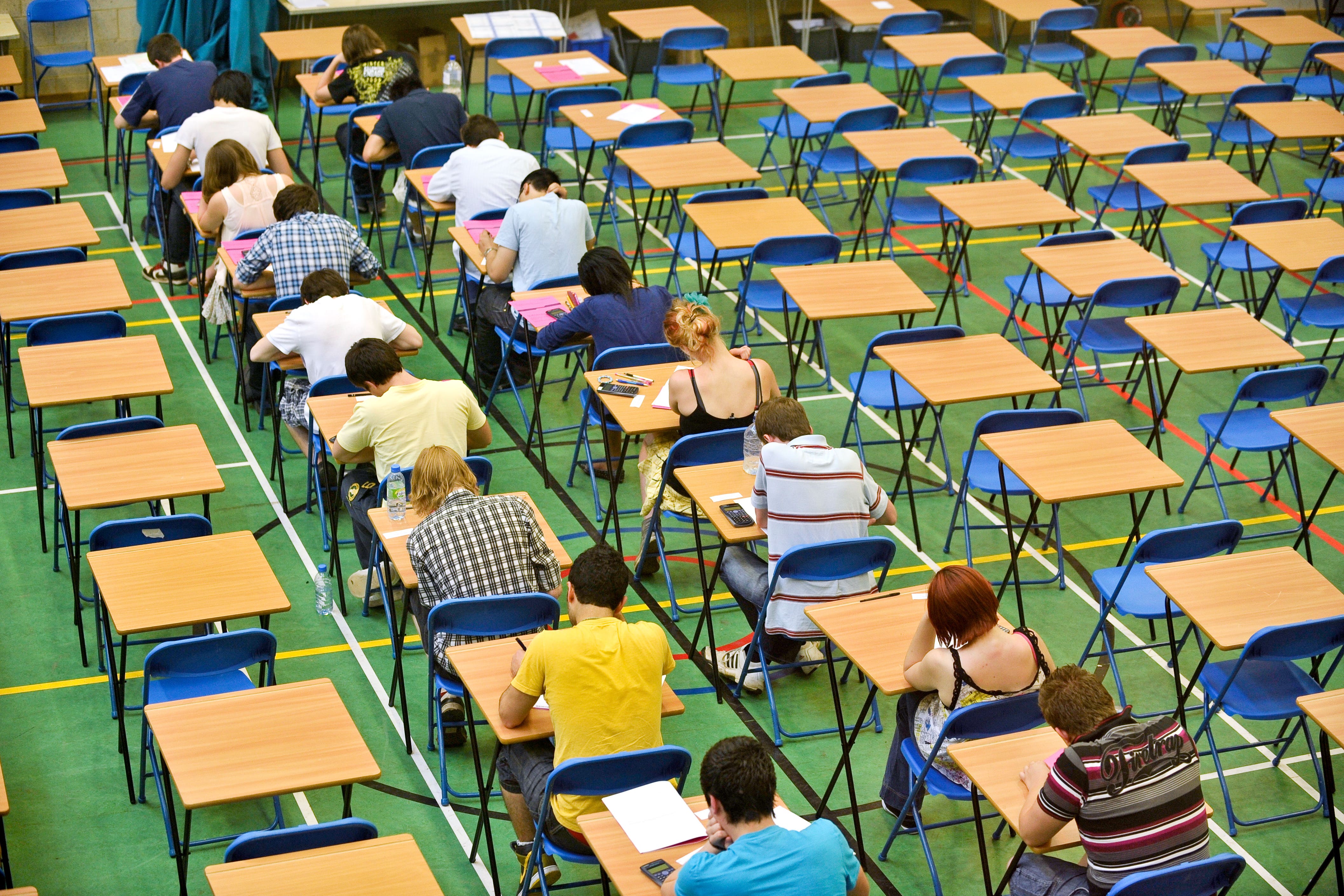 A-level students sit an A-level maths exam (PA)