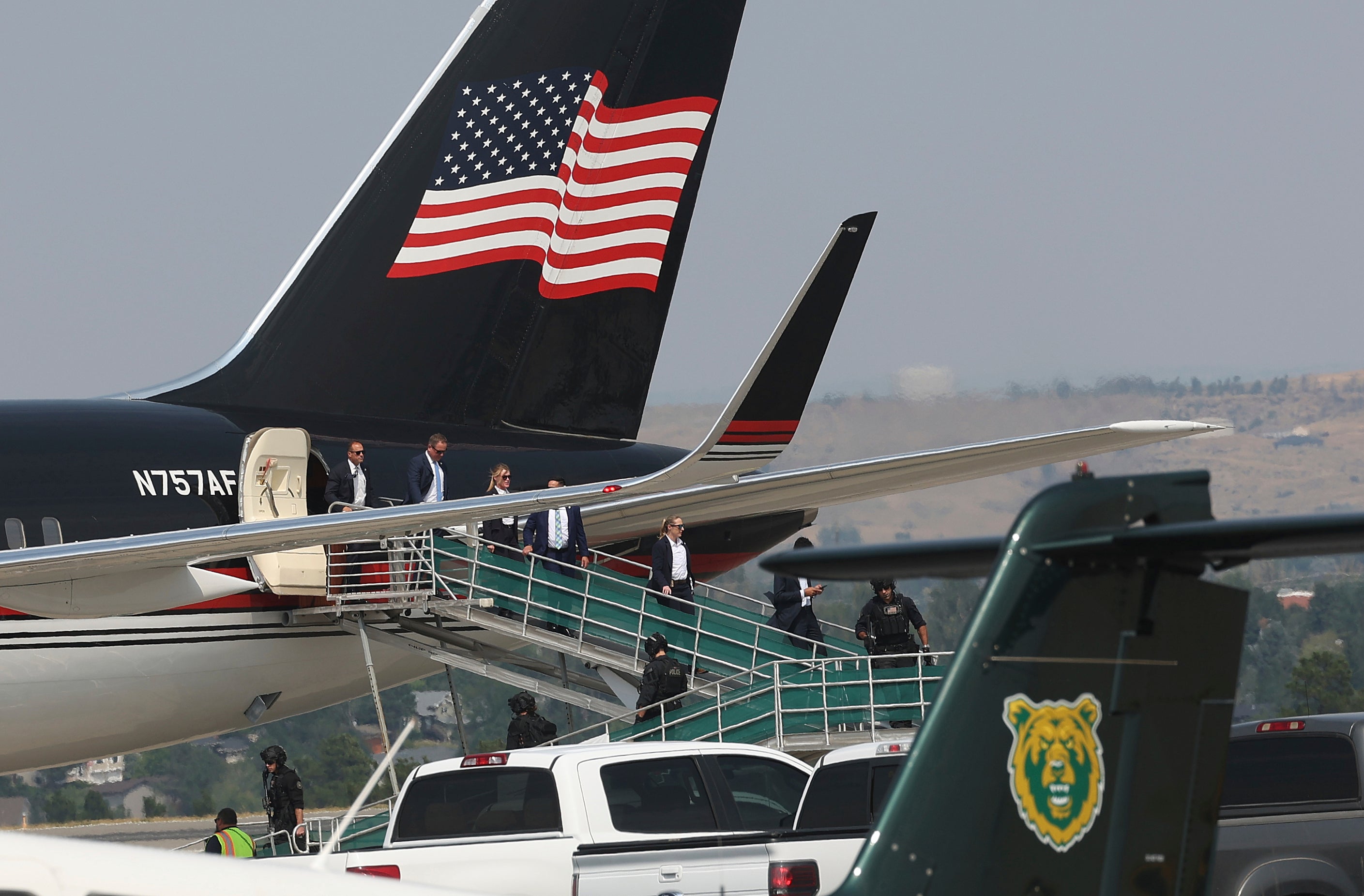 Members of former President Donald Trump's team disembark from his Boeing 757 after arriving at the Billings Logan International Airport in Billings, Mont., on Friday afternoon, Aug. 9, 2024, enroute to Bozeman