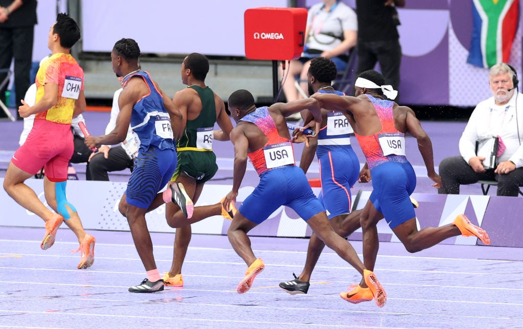 Christian Coleman attempts to pass the baton to USA teammate Kenny Bednarek