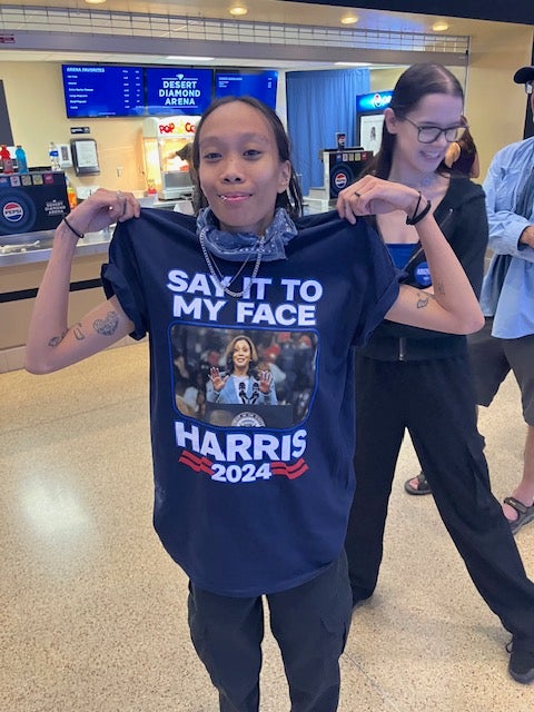 Charlotte Dirige wore a shirt with Vice President Kamala Harris saying ‘say it to my face’ during a rally in Glendale, Arizona