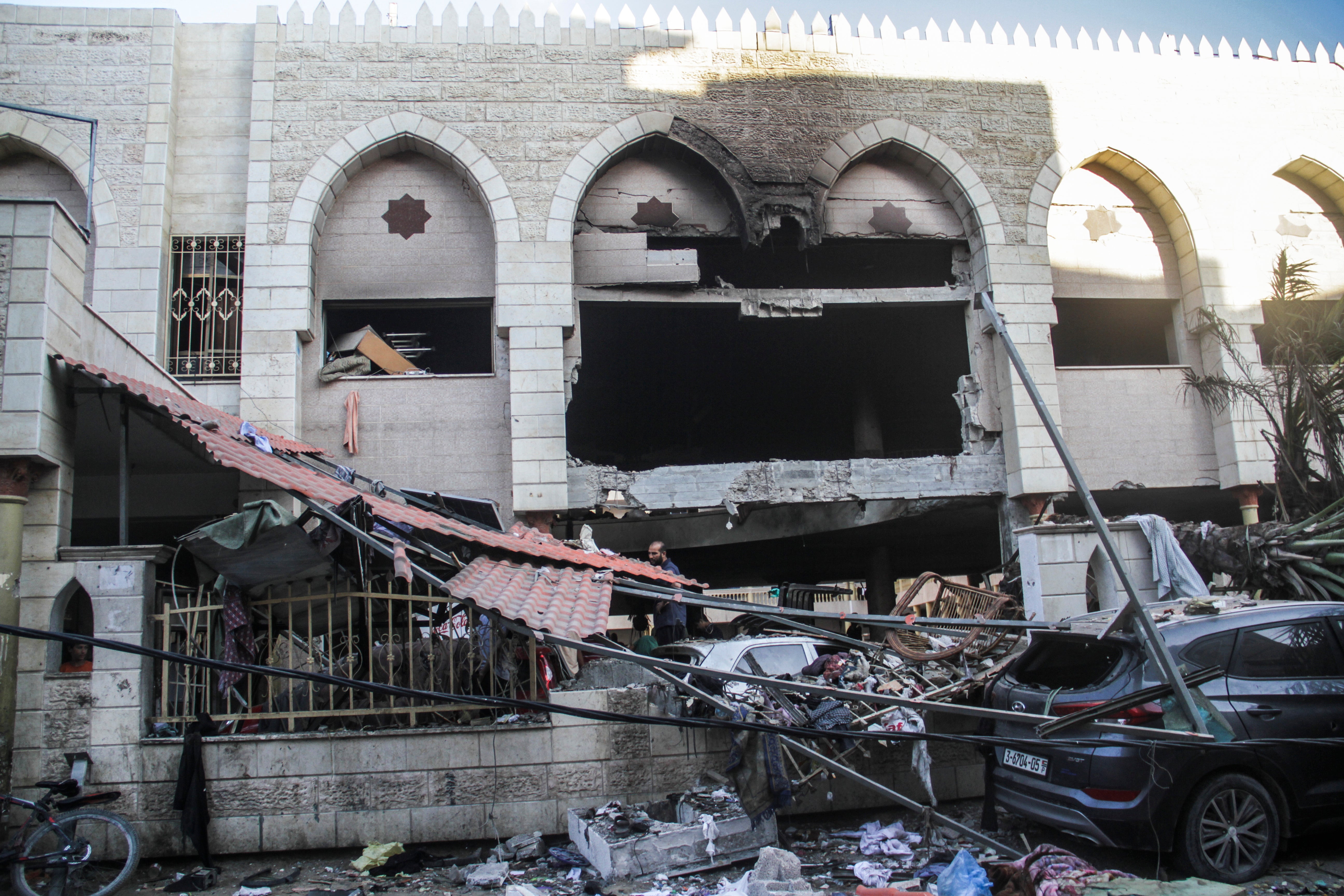 Palestinians inspect the damage following an Israeli strike on the Al-Taba'een school in the Daraj Tuffah neighborhood of Gaza