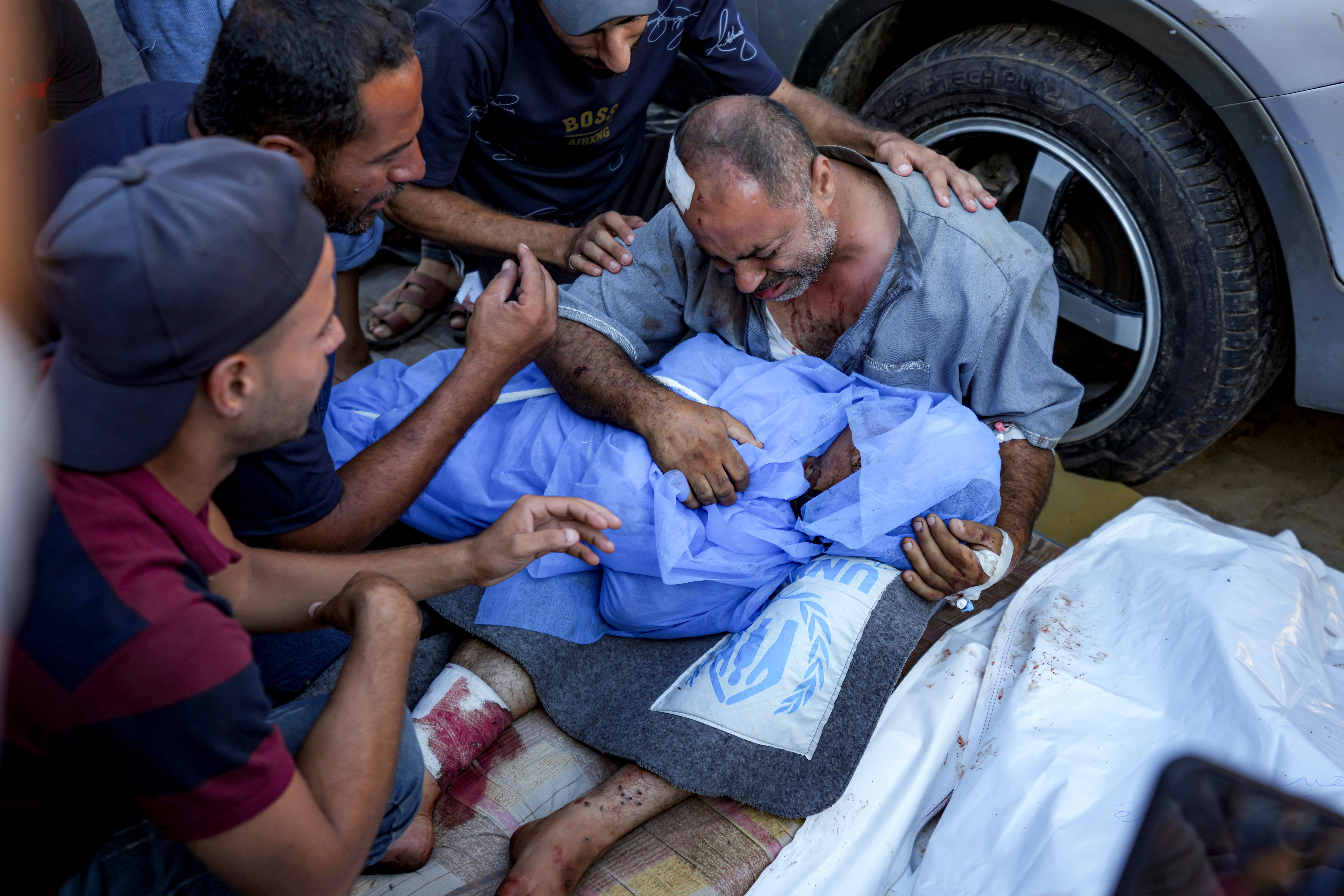 A Palestinian man mourns for a relative killed in the Israeli bombardment of the Gaza Strip, at a hospital in Deir al-Balah