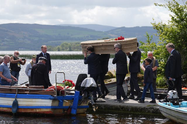 The coffin of Irish writer Edna O’Brien travels by boat across Lough Derg from Mountshannon to Holy Island in County Clare ahead of her burial (Niall Carson/PA)